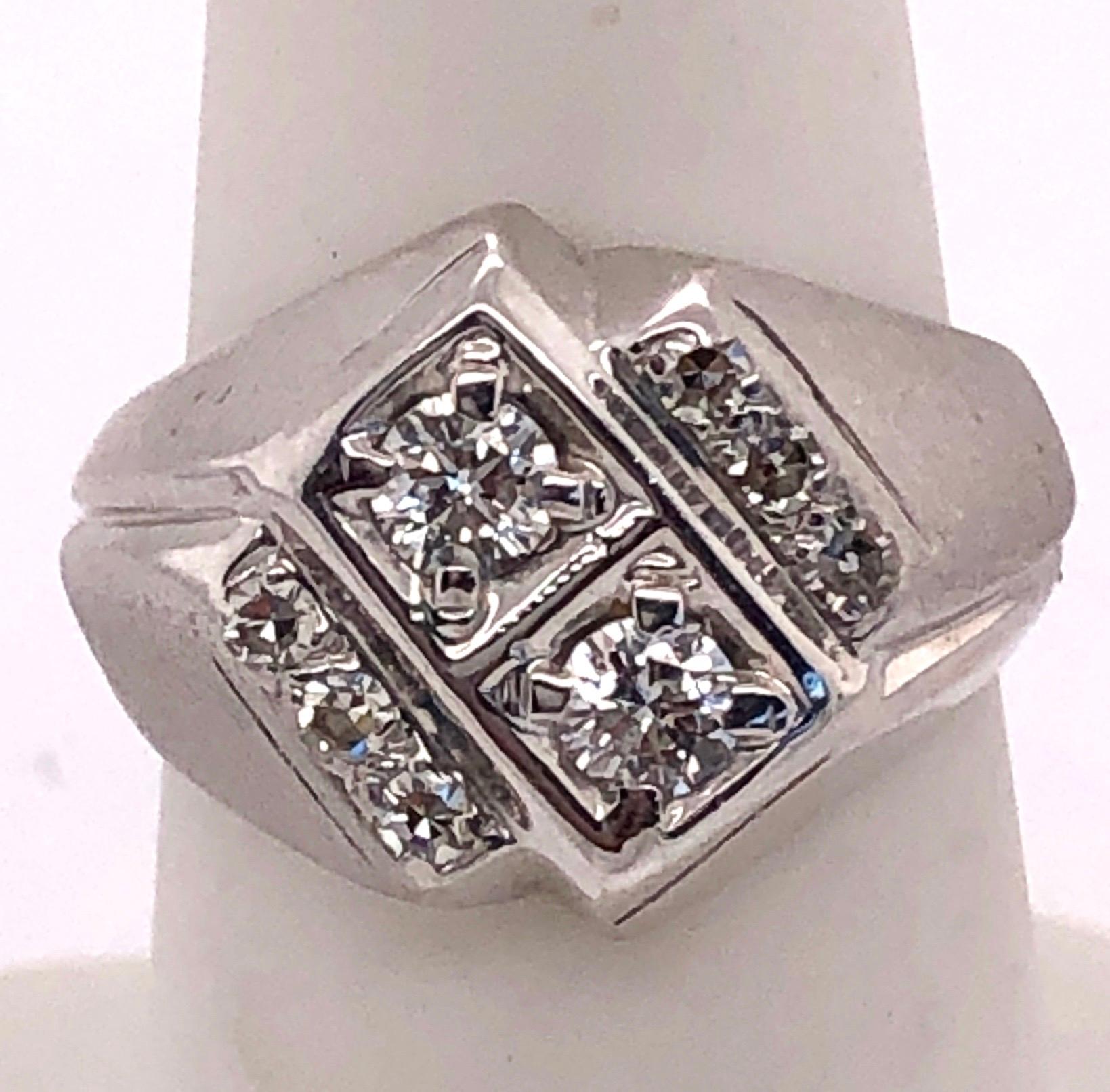 14KT White Gold and Diamond Ring having .62 Ct of Diamonds. Two large stones sit center and are flanked by three diamonds on each side. 8 grams total. 
Size 6.5 with 2 Round Diamonds 0.50 tw and 6 Rounds 1.2 tw 
