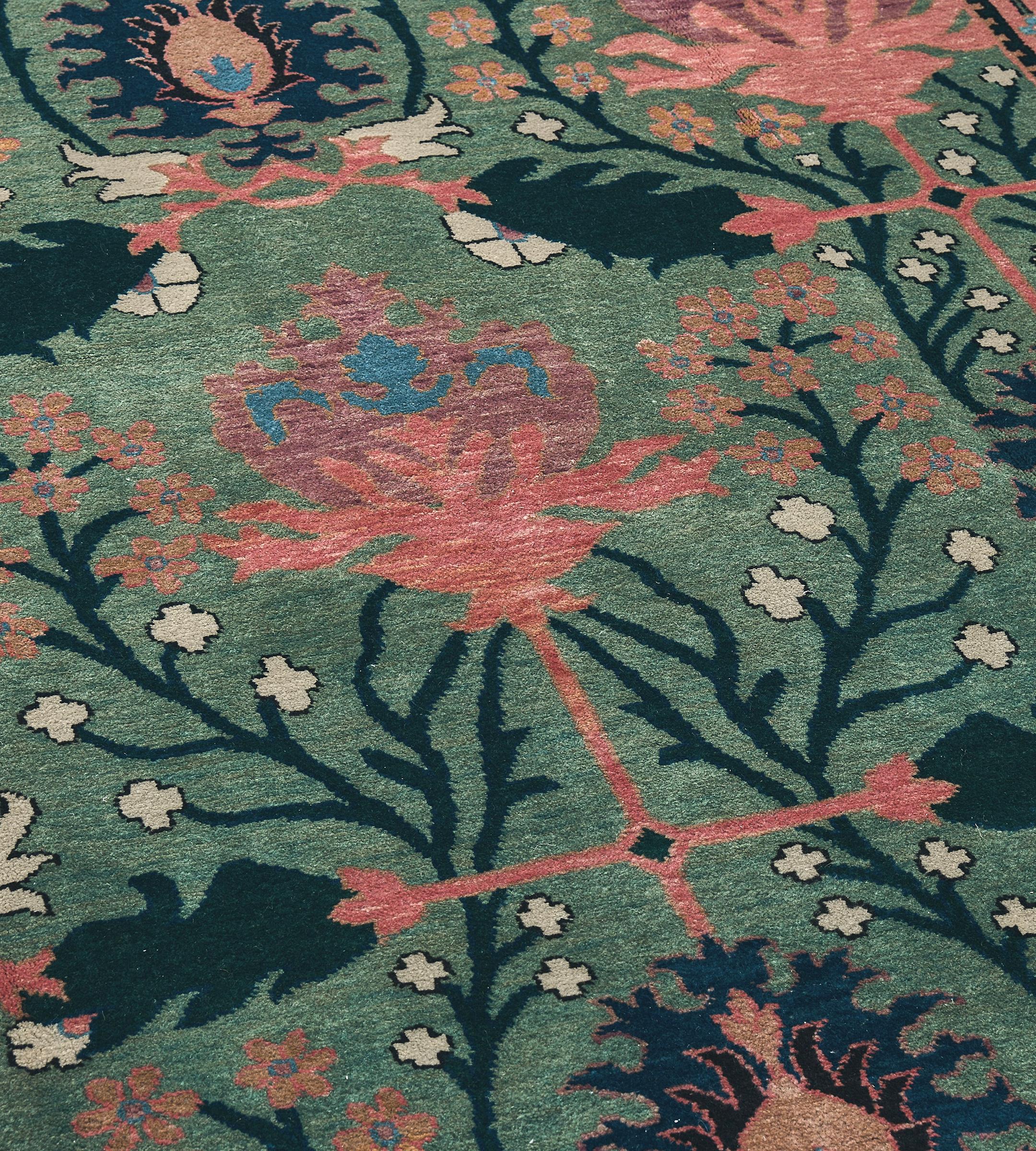 Originally designed and crafted in Donegal Ireland in early 1900s, this magnificently decorative brand new Donegal-inspired carpet was hand woven and created in Kashmir. This Arts & Crafts carpet features large scale patterns with masterful color