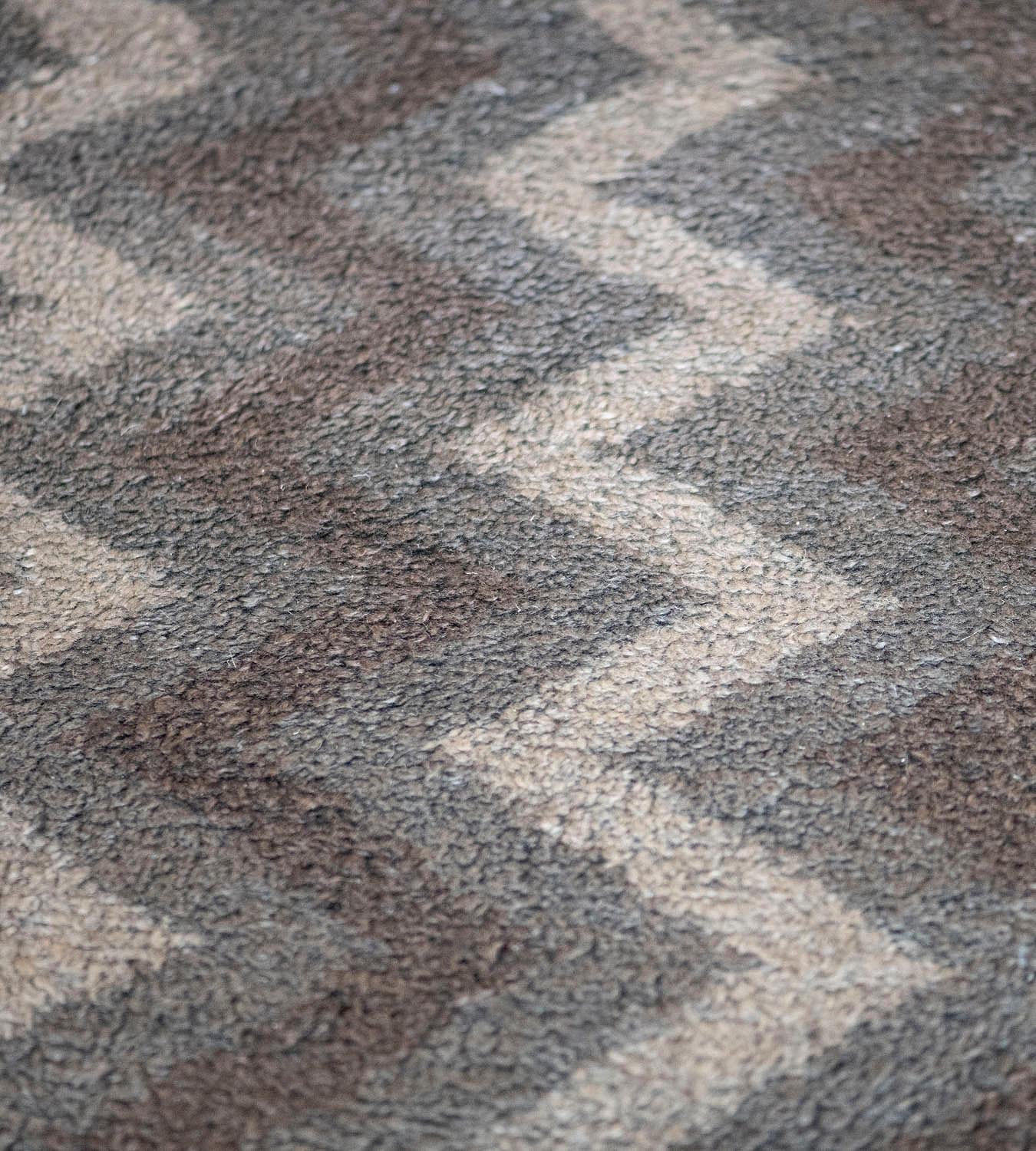 The Mansour Modern collection is primarily inspired by vintage rugs whose geometric designs are relevant as ever in the 21st century. This deep pile mohair rug features alternating ivory, brown, and taupe stripes in a playful vertical zig-zag