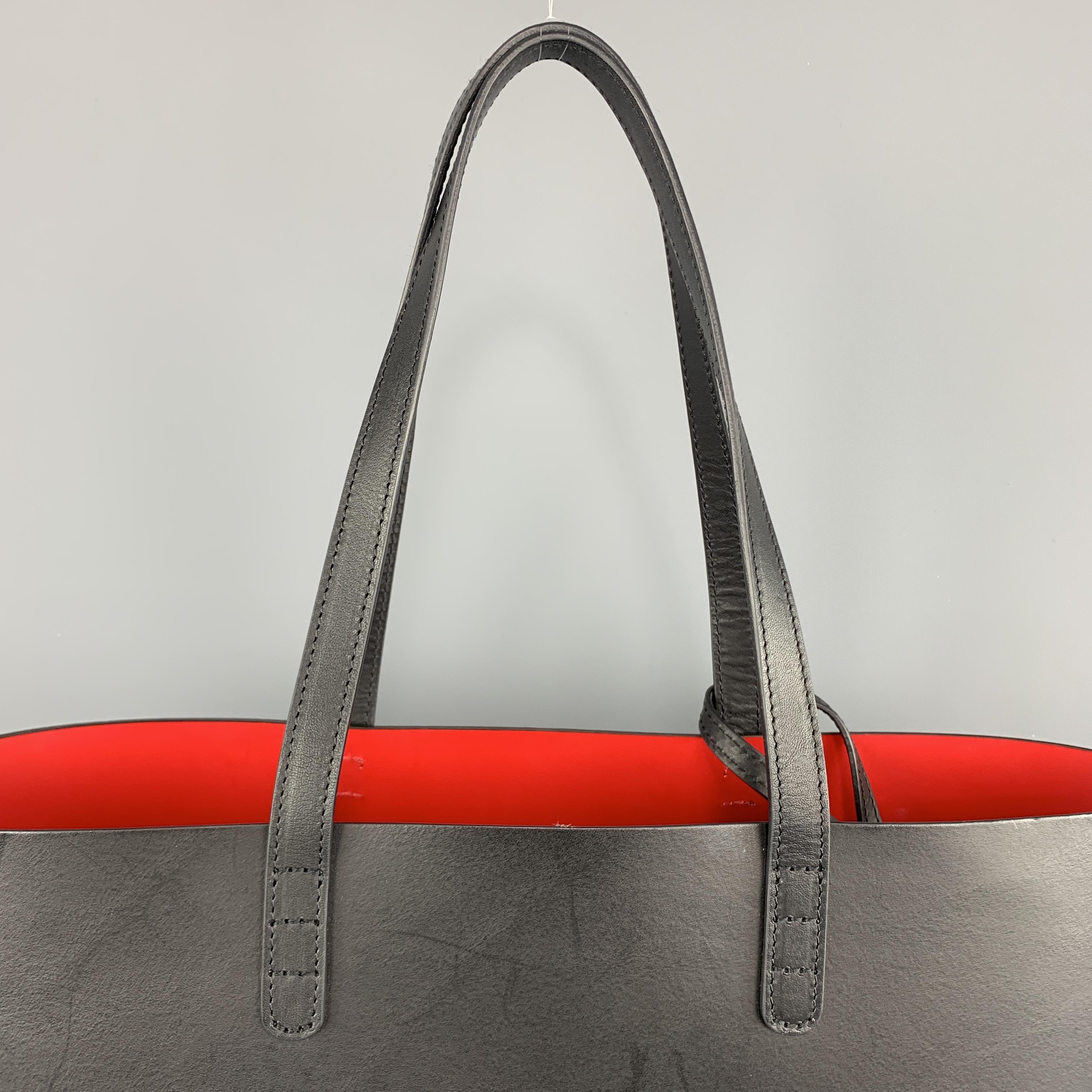 MANSUR GAVRIEL Tote bag comes in a smooth solid black leather, with a red interior, thin straps at drop, and a detachable wallet. Wear. Made in Italy.
 
Very Good Pre-Owned Condition.
 
Measurements:
Length: 15 in.
Width: 5.5 in.
Height: 9.5