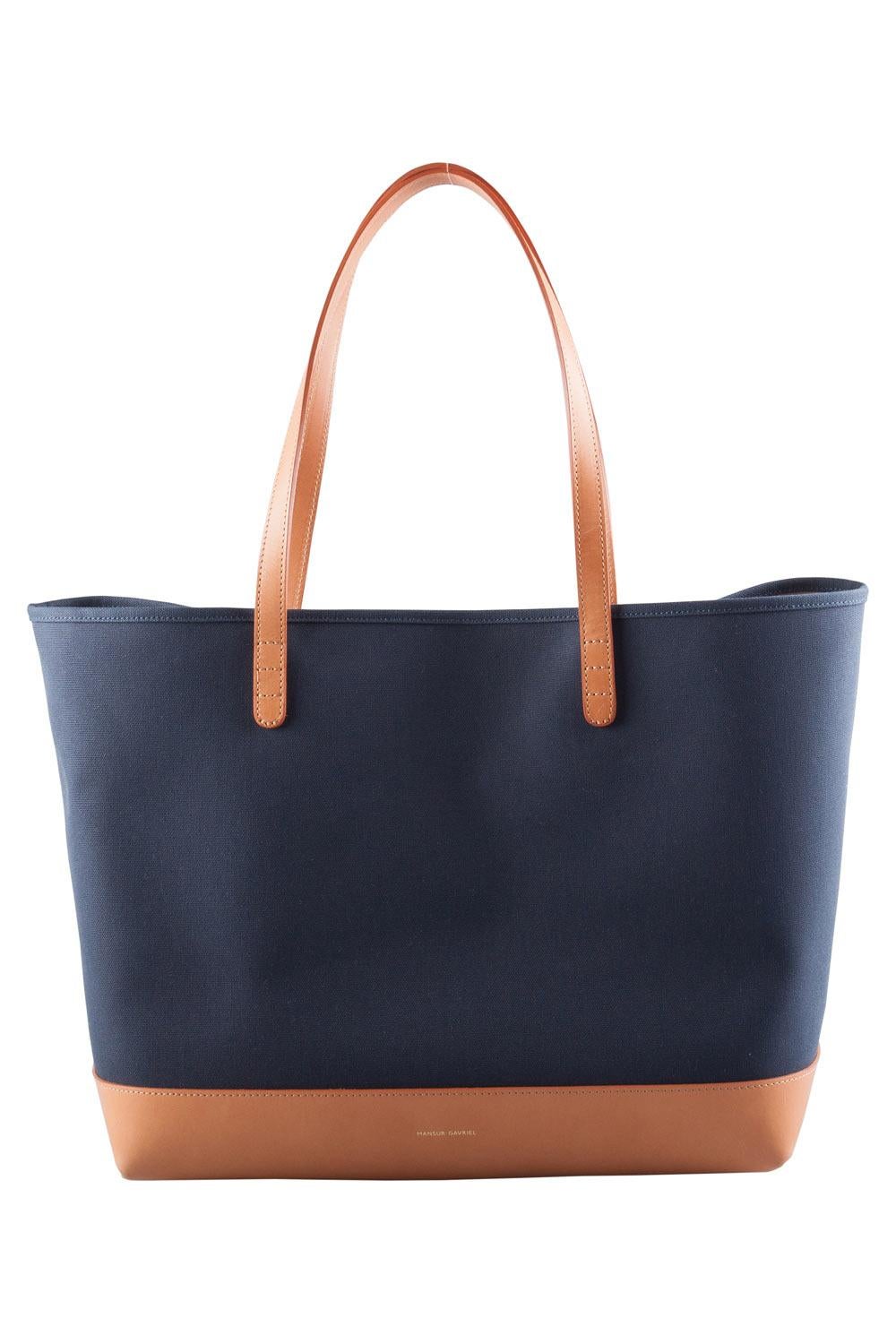 Crafted by Mansur Gavriel, this canvas and leather tote is designed in the dual tones of blue and cream. The bag features a wide interior lined from fabric and leather. It can easily house more than just your essentials. This accessory comes with