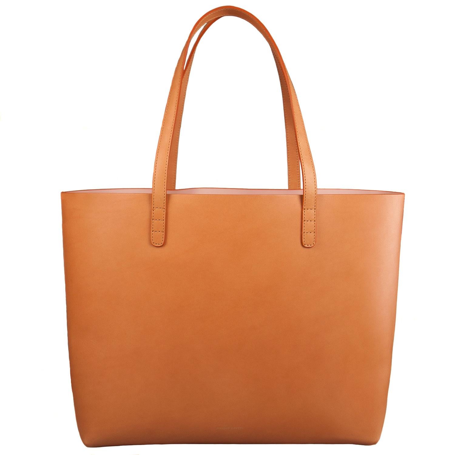 Masterfully crafted with leather and accompanied by a pouch, this luxurious tote essays functional fashion! This piece from Mansur Gavriel features two handles and a spacious leather interior. It will be a wonderful everyday accessory.

Includes: