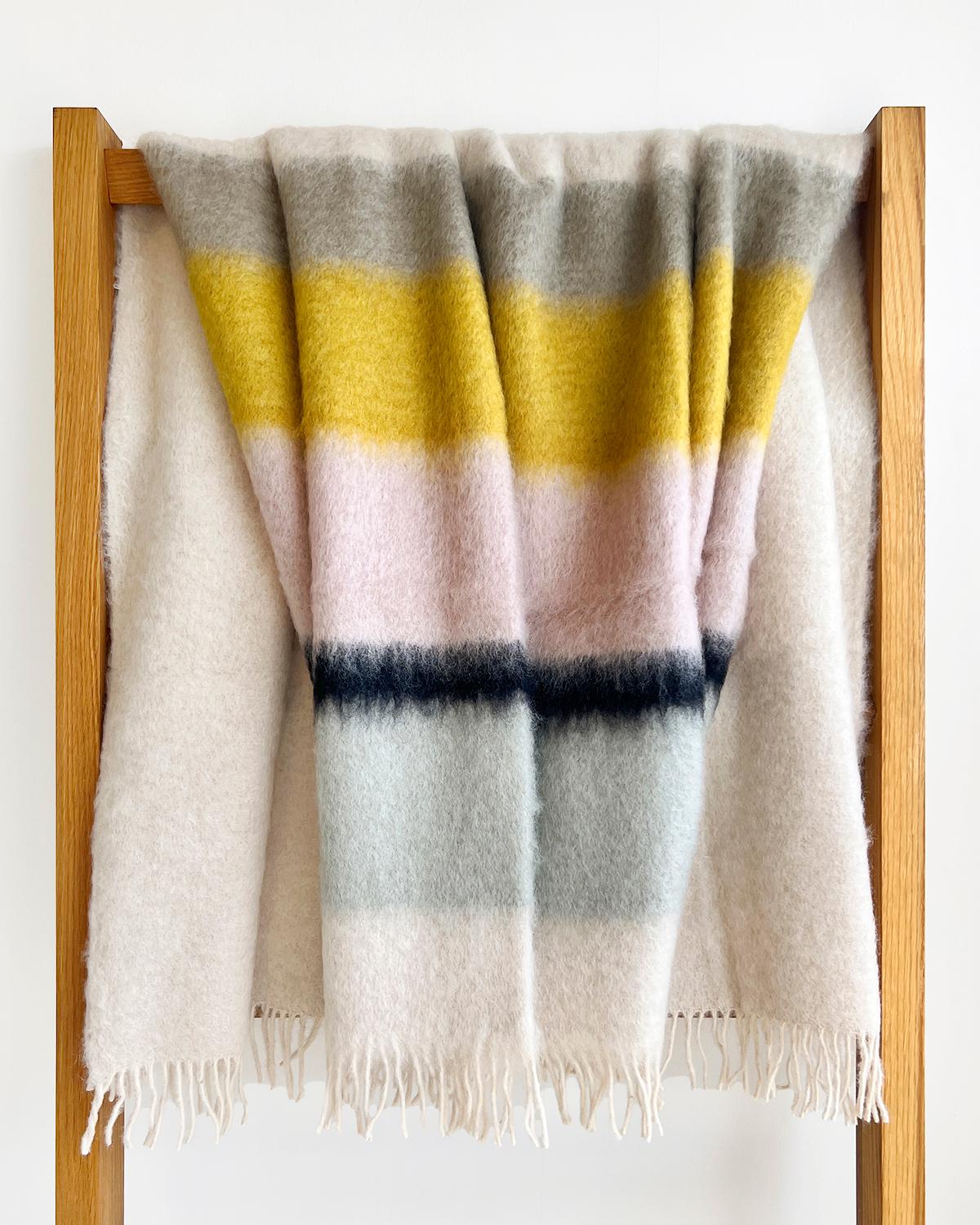 This Color Block Mohair Blanket Throw is the perfect way to add a cozy, pastel-hued touch to any room in the house. Its handmade Spanish construction ensures superior quality, while its fuzzy, warm materials are sure to bring you comfort and add a