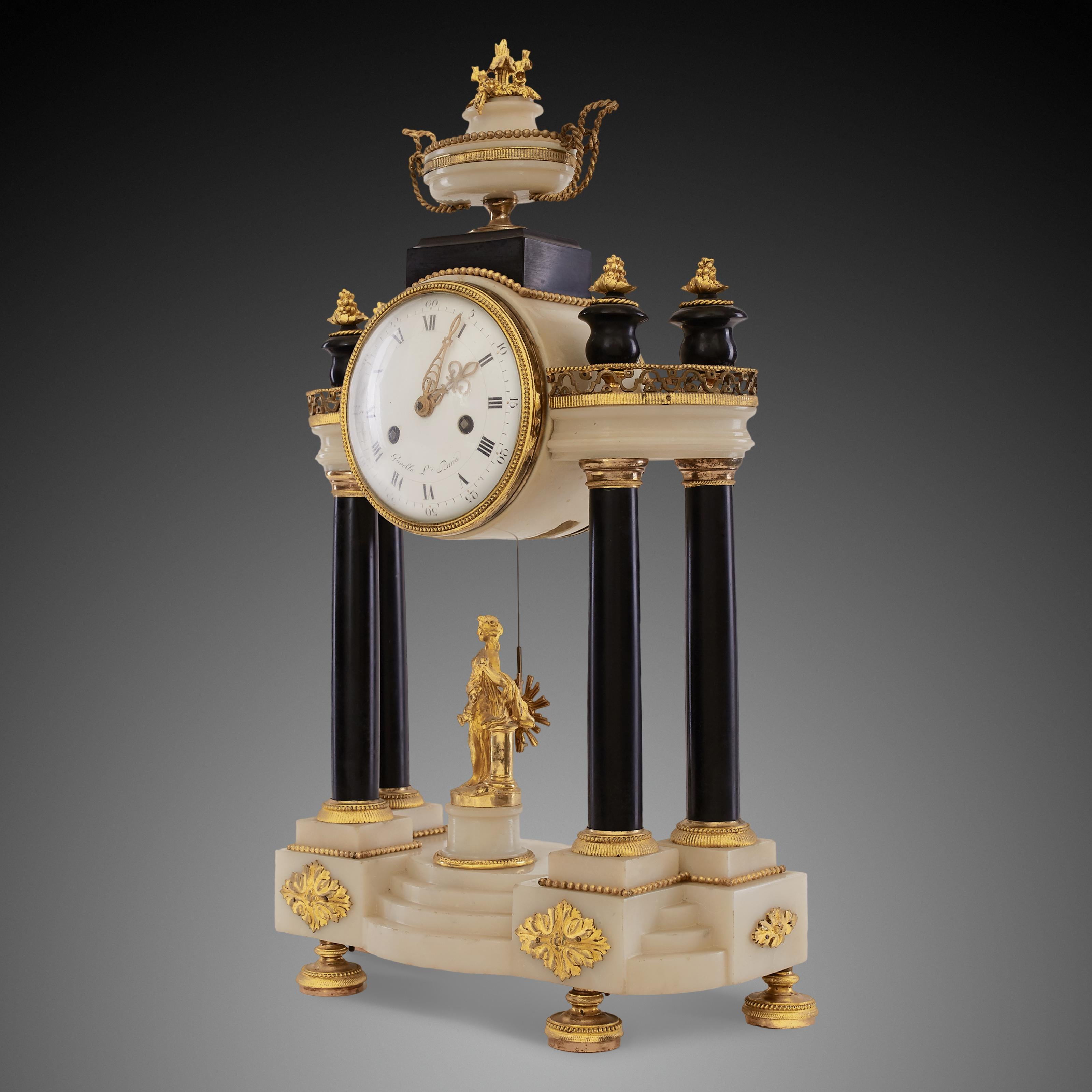 Antique French portico clock is crafted in Empire style during the reign of Napoleon in the 19th century. The Empire style gives the antique clock symmetry on either side. When observed closely, the two sides of the pedestal are printed with