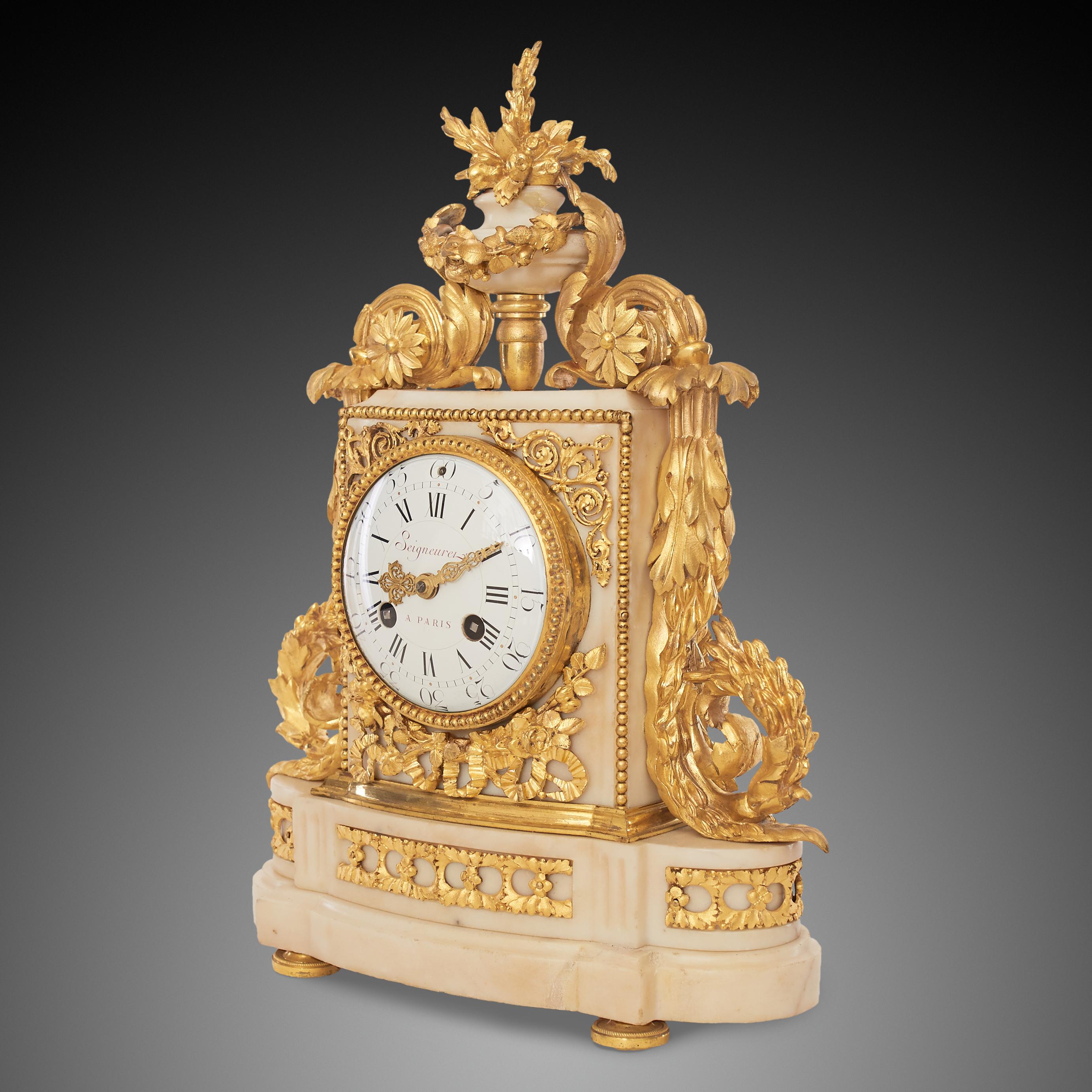 A Louis XV style marble mantel clock. Enamel dial with Roman numerals, signed with a red inscription 