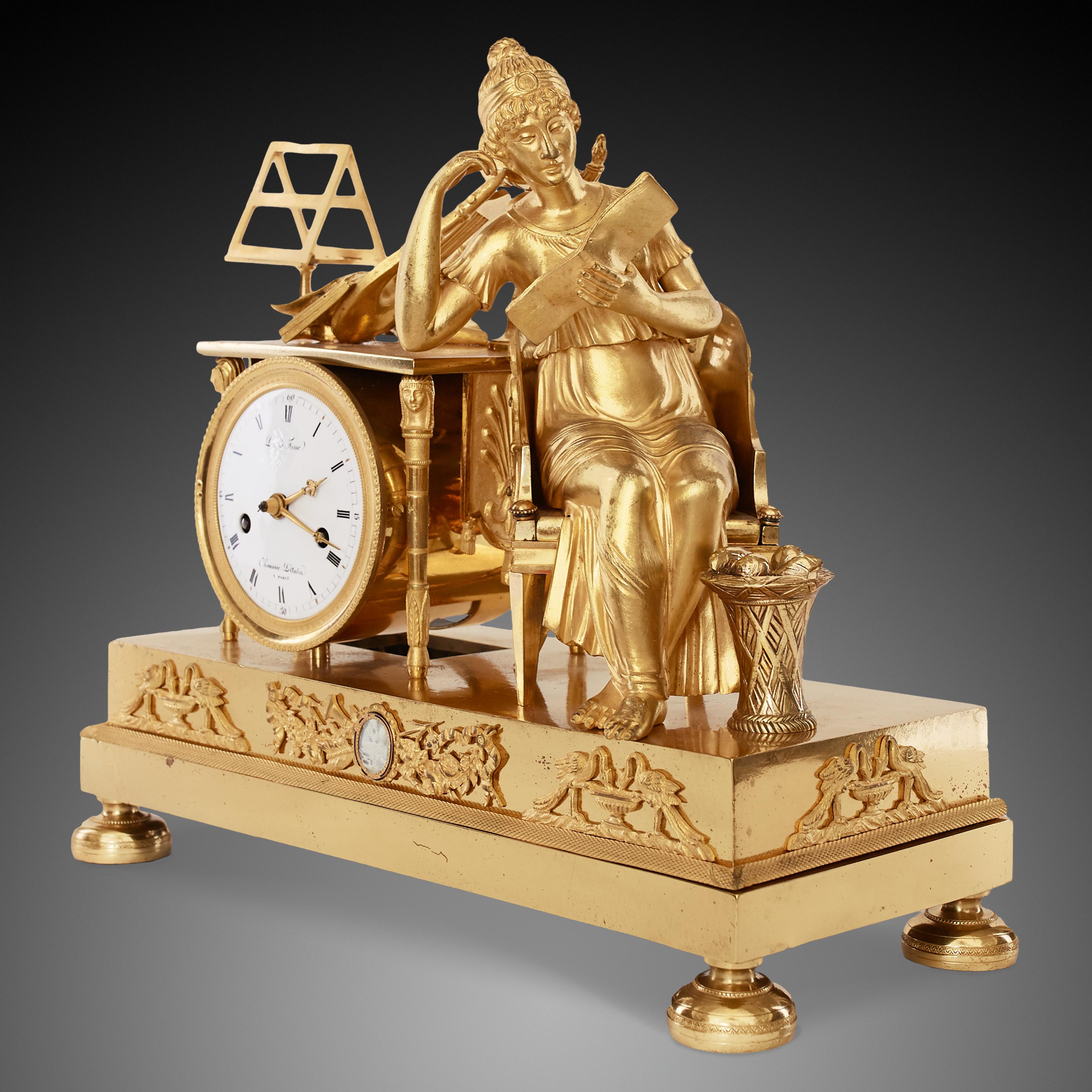 Very beautiful Empire clock on the theme of music. rare model, signed “Caillouet in Paris” Watchmaker referenced in the Tardy at the date of 1810. Scene decorated with a musician sitting in a finely decorated seat winding. she is reading a music