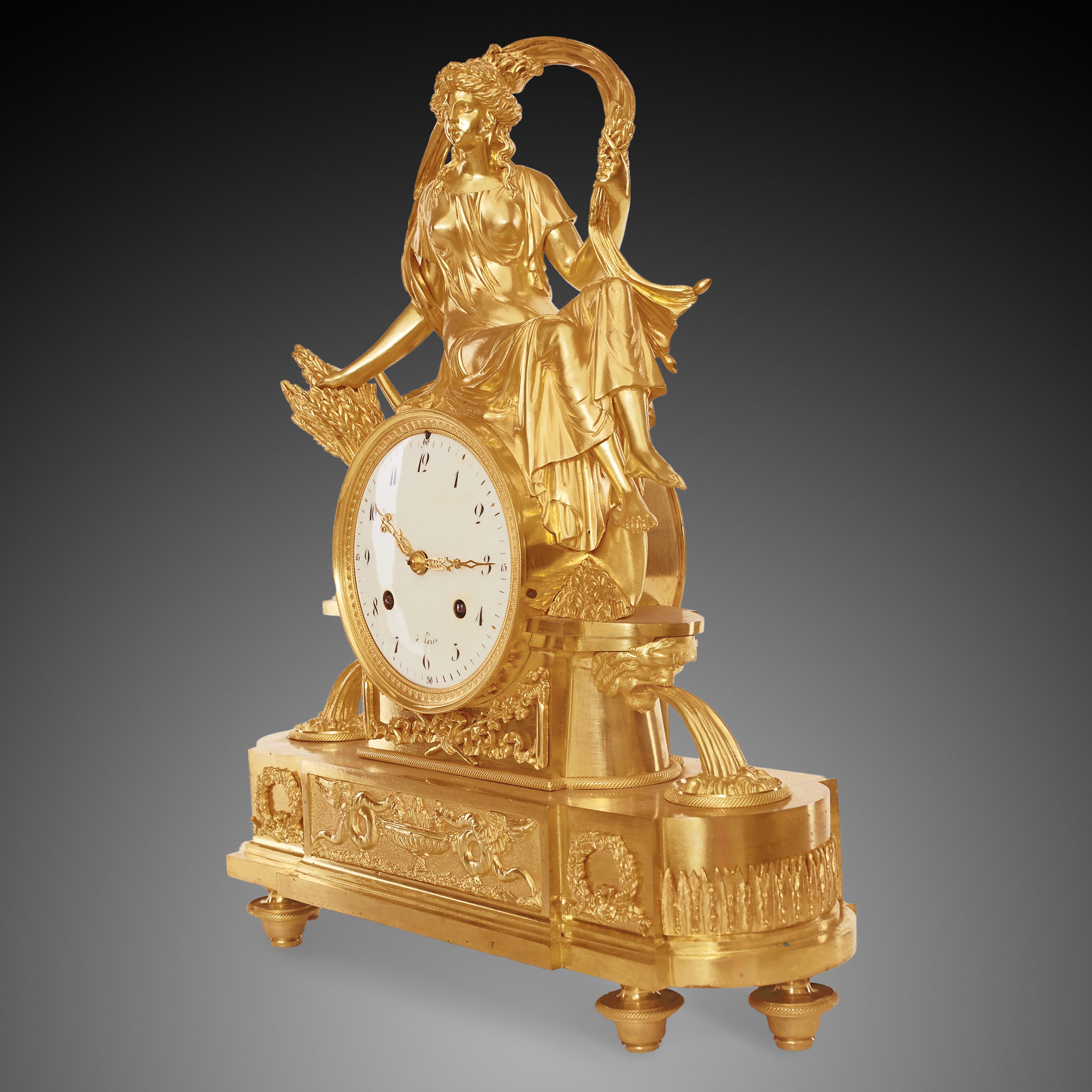 Empire clock signed à Paris 

The mantel clock is in gilded bronze representing Ceres as a goddess of fertility, agriculture, grain crops and motherly relationships. In ancient Rome she was worshipped by people in order to provide her favor in the
