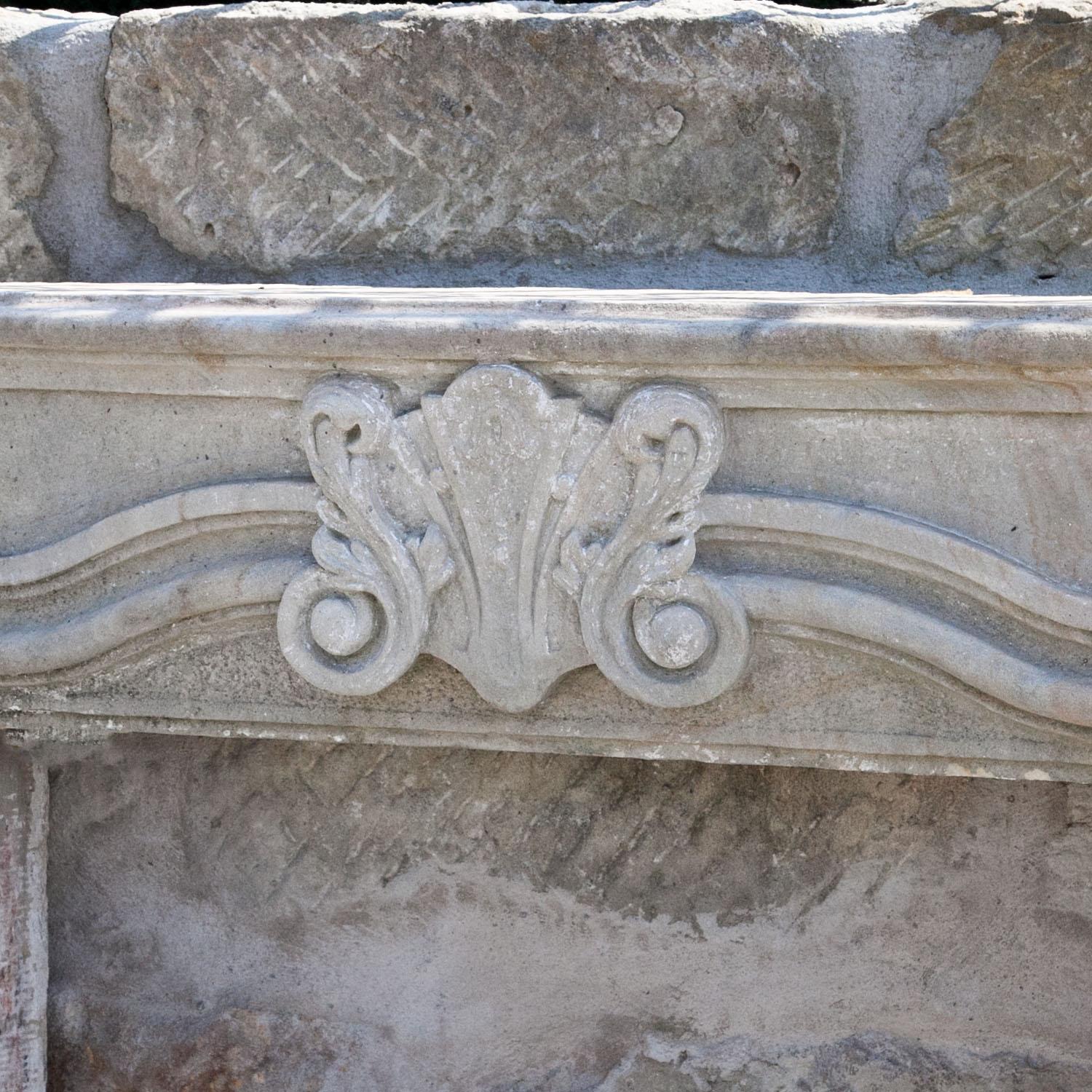 Mantel piece out of sandstone with a rocaille ornament on top and profiled, slanted sides. The mantel comes from a Saxonian castle.