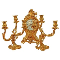 Antique Mantelpiece, a Clock and Two Candelabras