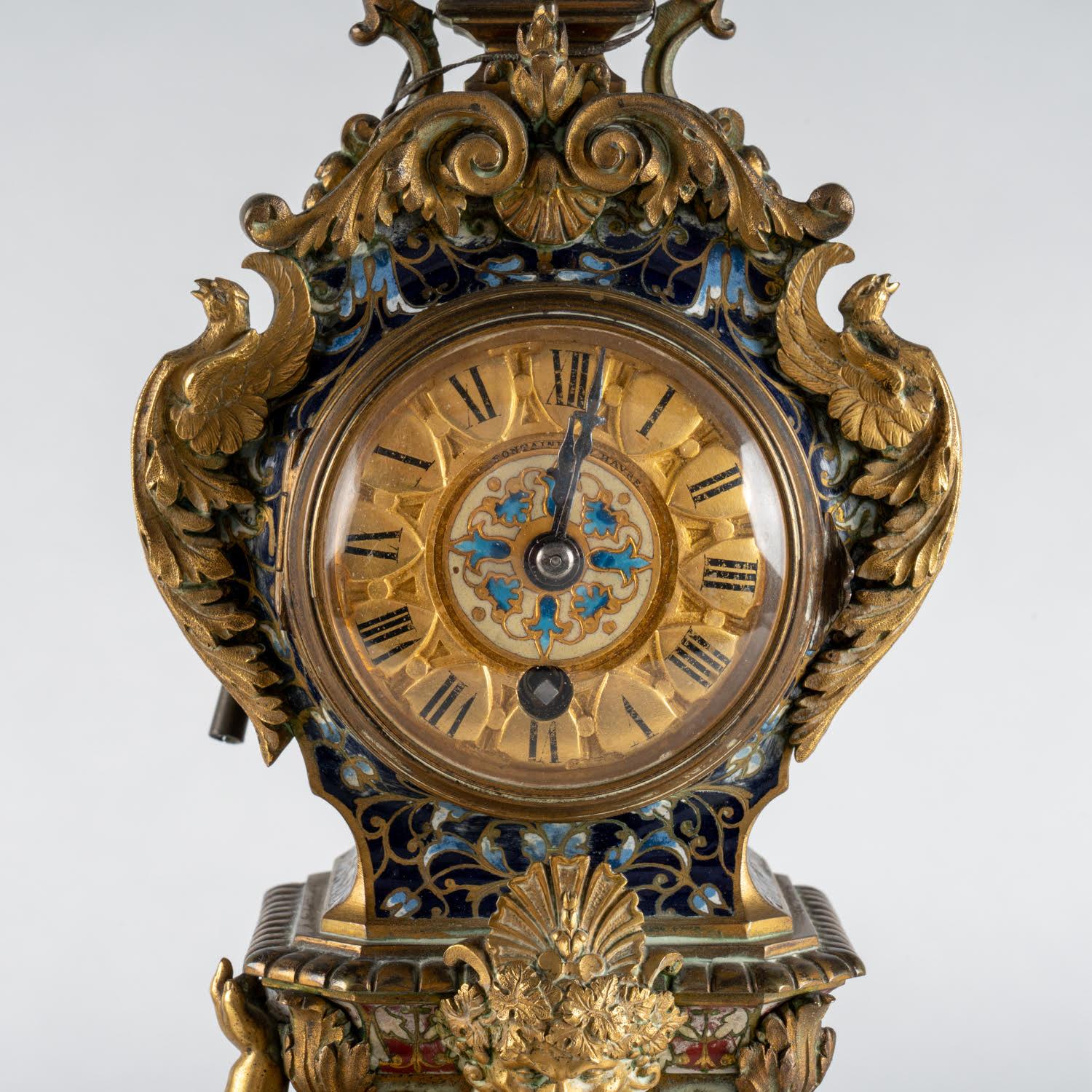 Mantelpiece from the 19th century, Napoleon III period.

Clock and its two candelabras in gilt bronze, enamels and onyx, beautiful work of the 19th century, Napoleon III period, (mechanism in need of restoration).    
Clock: h: 34cm, w: 10.5cm, d: