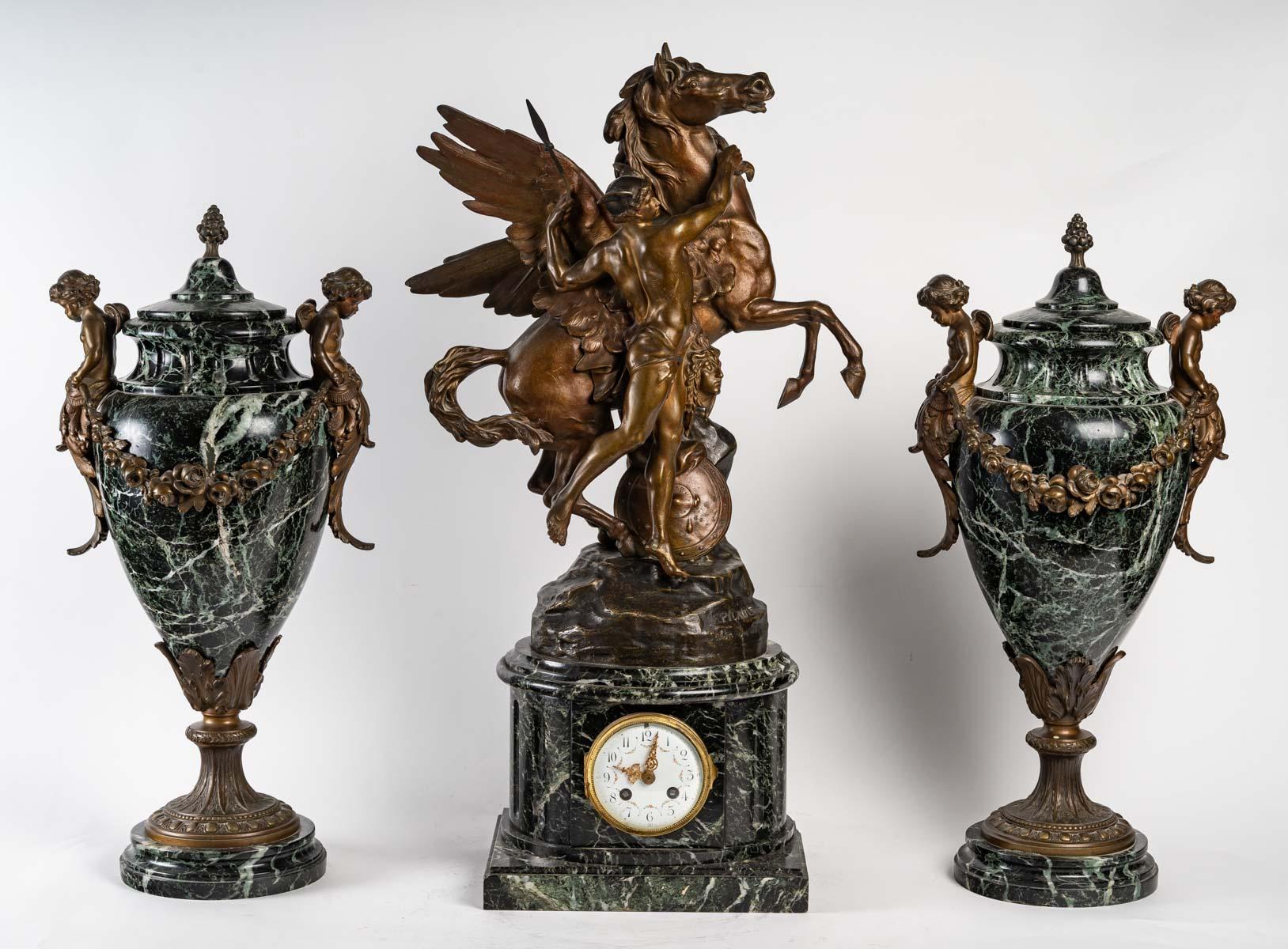 Mantelpiece in regule, sea green marble, two cassolettes and a clock by Emile Picault (1833-1922).

Clock - H: 70 cm, W: 41 cm, D: 20 cm Mantelpiece in regule.