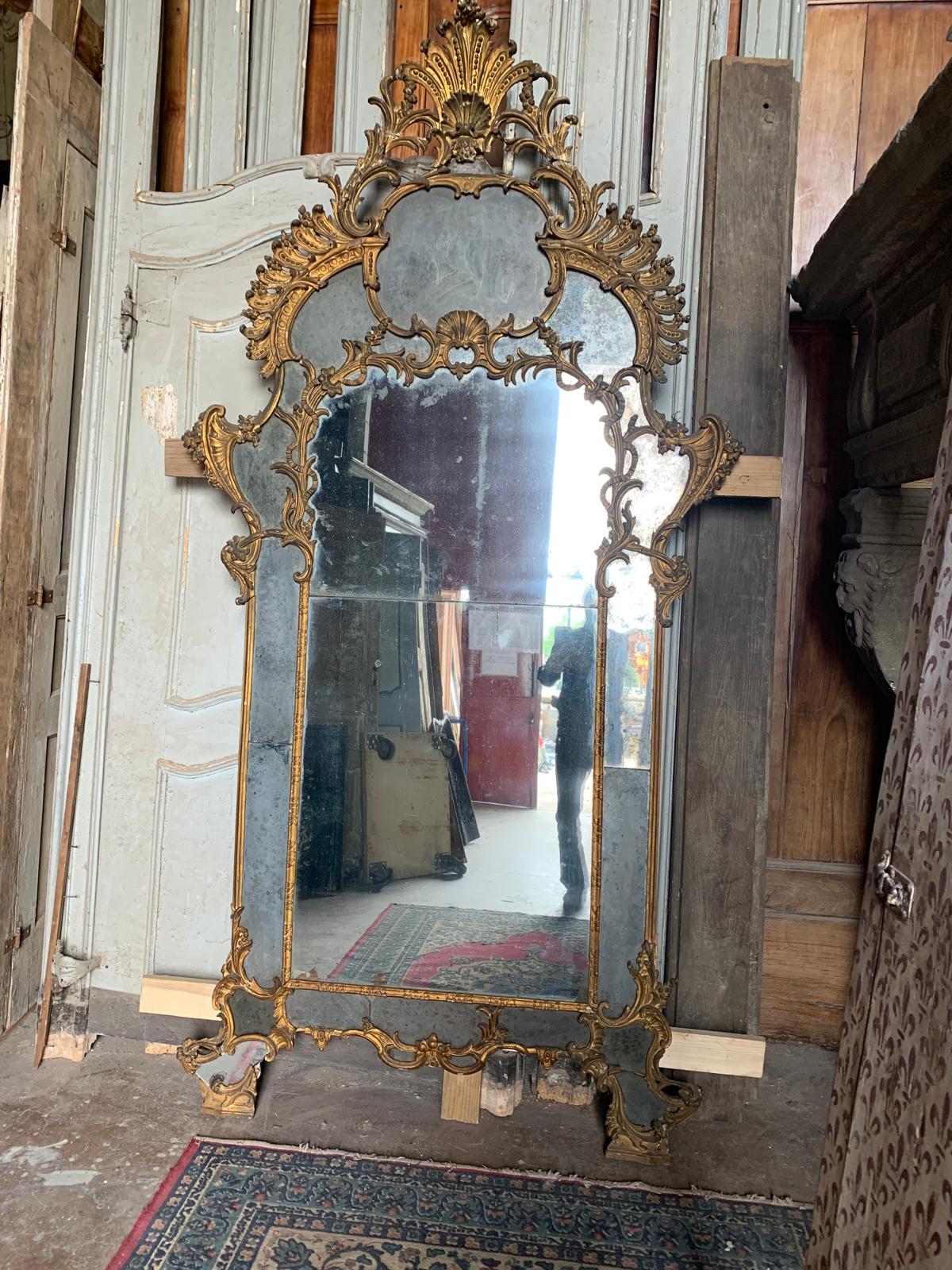 Antique Mirror, very ancient wooden fireplace mirror richly carved with baroque scrolls and then gilded with precious pure gold leaf, gold in patina acquired over the centuries, comes from an ancient castle in Piedmont, Italy, original from the