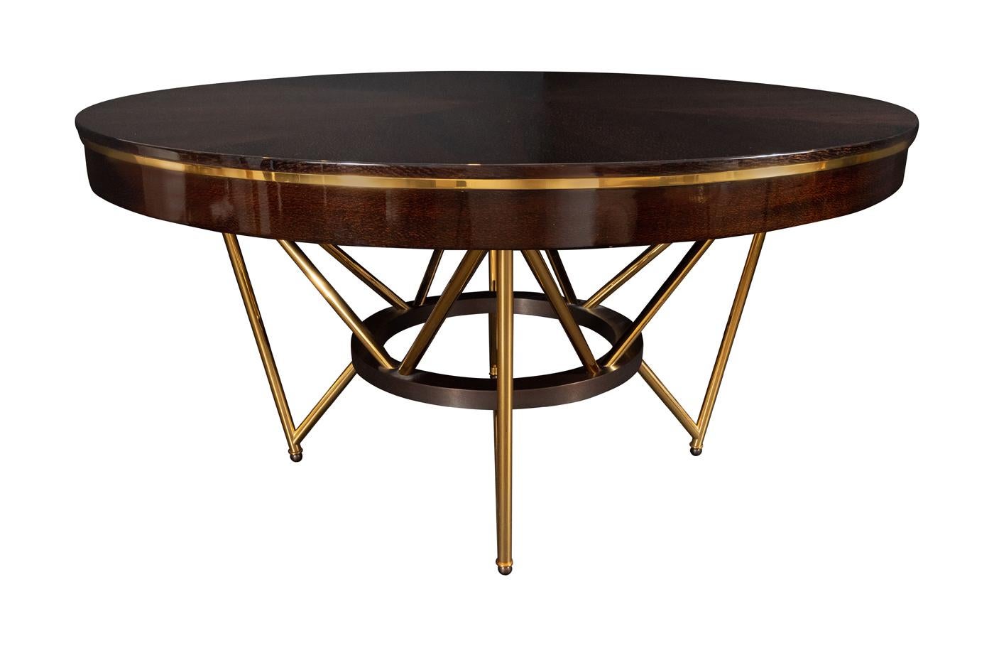 High gloss ebonized lacewood top with polished golden brass apron detail on matching base with dark oxidized bronze centre ring and ball feet.