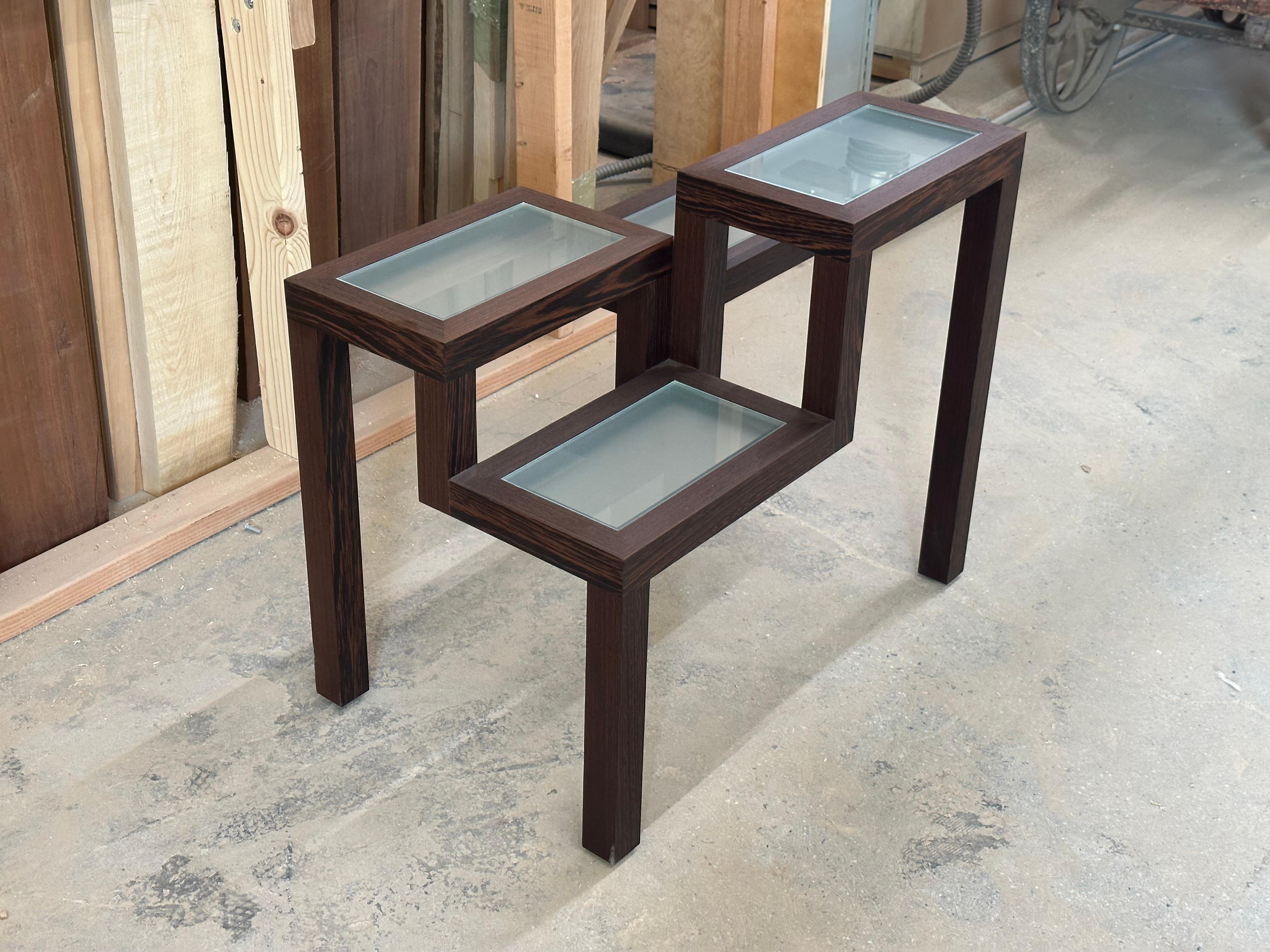 This 4-tiered Wenge and Glass end table, with surfaces at 15