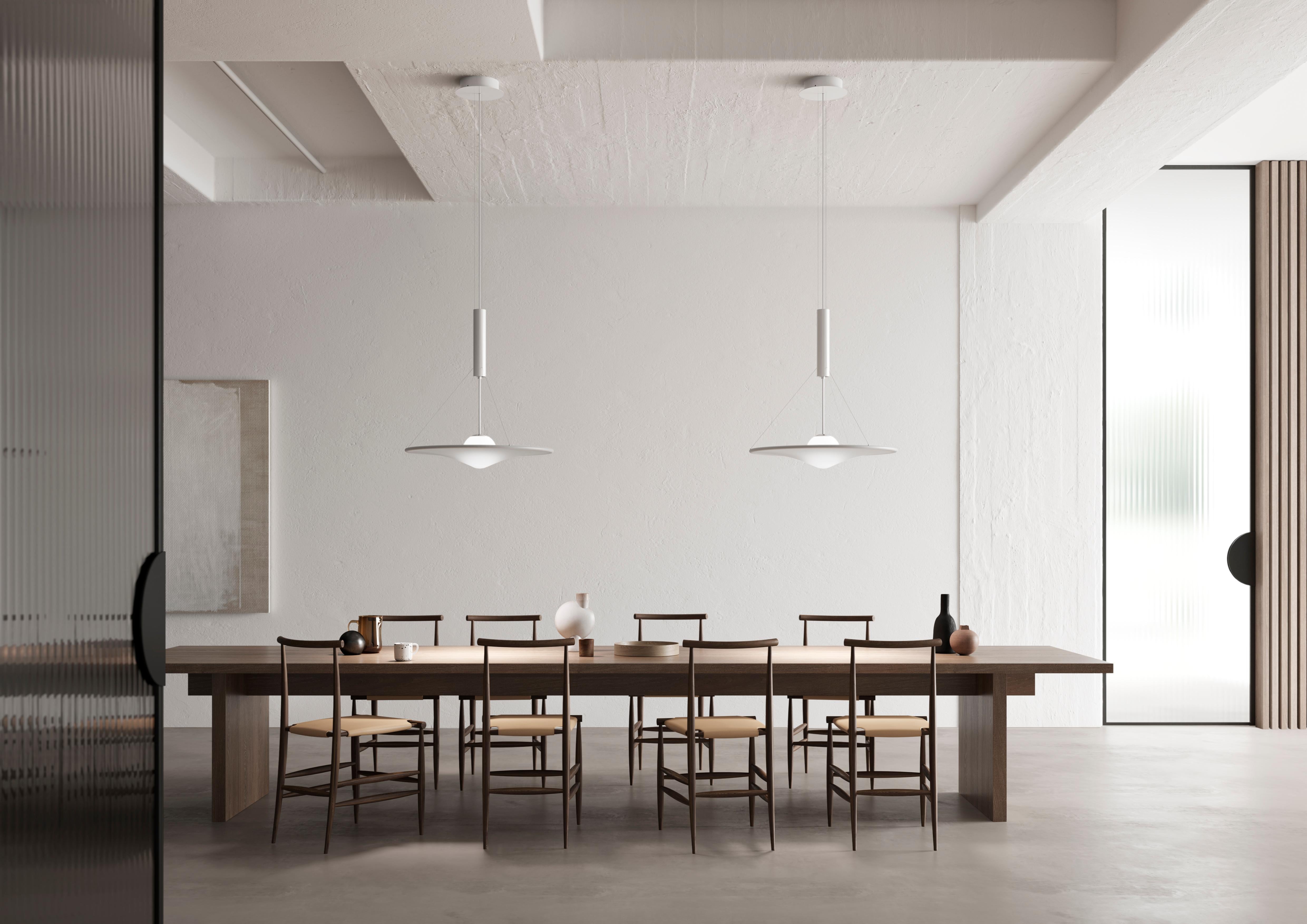 Manto 70 (small) – designed by Davide Besozzi – is a collection of suspension lamps, available in three sizes.
An opaline white blown glass sphere contains a LED light source and is supported by a telescopic arm, which can move the diffuser in