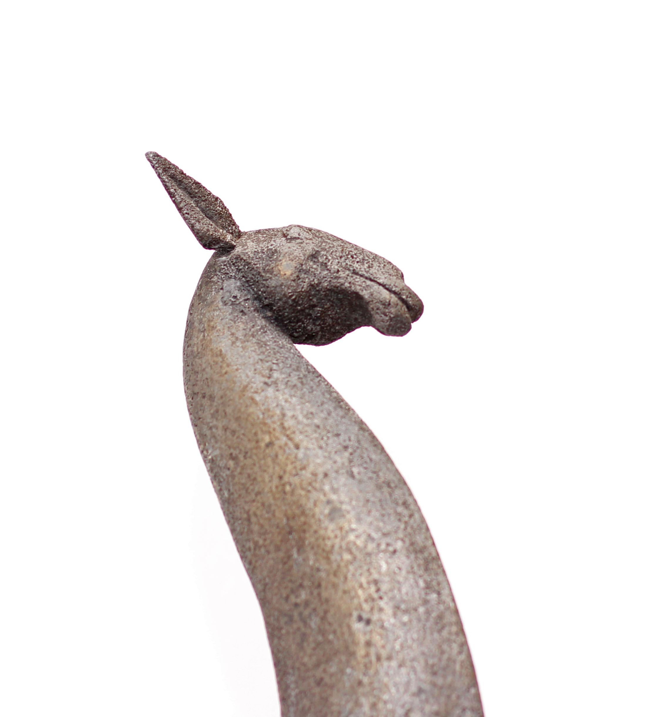 A large and early sand cast aluminum modernist sculpture of a giraffe by Cuban American artist Manuel Carbonell. Pedestal included. Measures: Height is 73” with base.
Carbonell’s early sculptures where sand cast and unique. This is an edition of