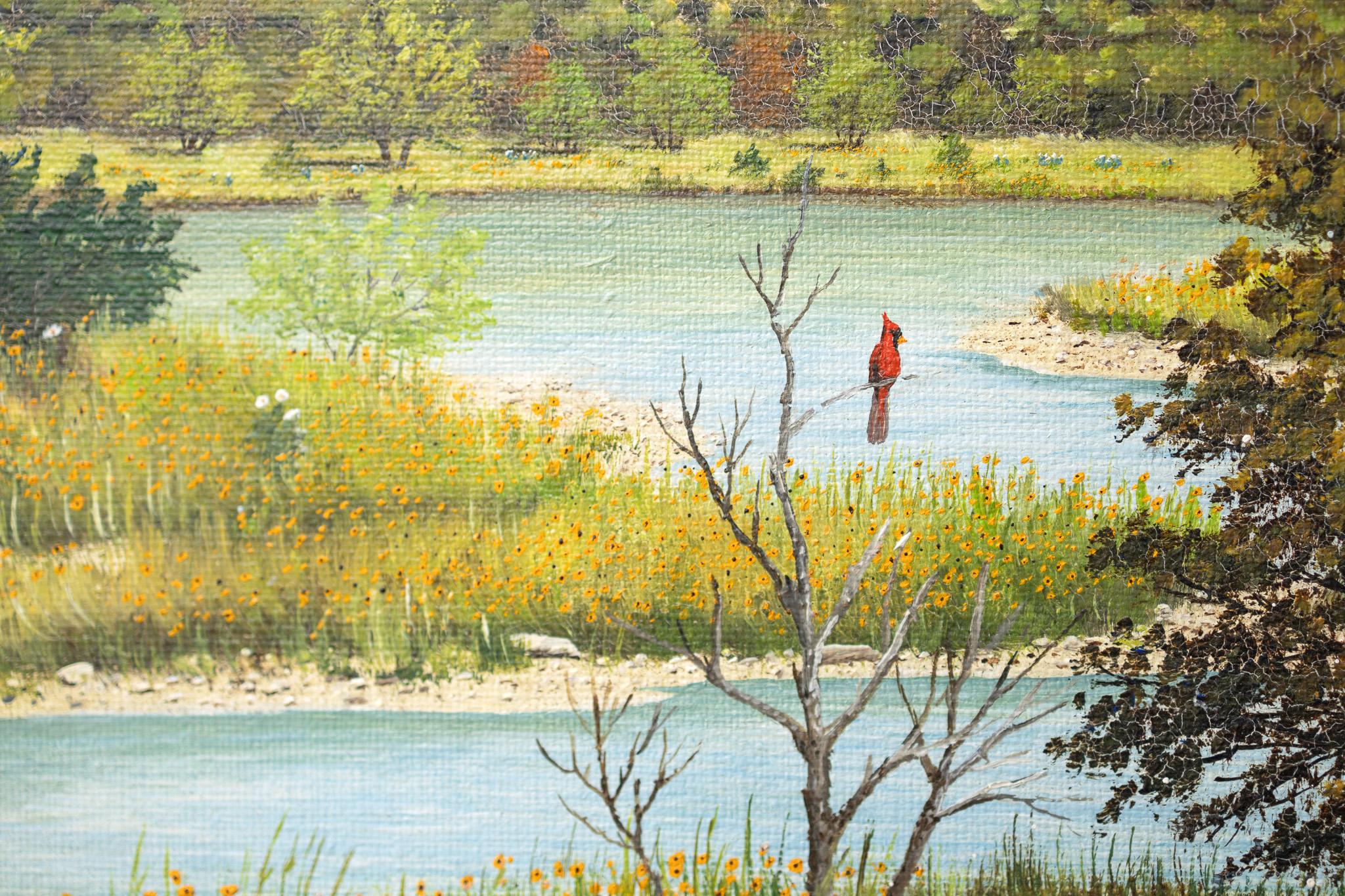 Cette peinture joyeuse de l'artiste texan Manuel Garza représente une vue d'une rivière sinueuse au printemps avec des fleurs sauvages jaunes. Un cardinal rouge vif est perché au sommet d'une branche, admirant le paysage texan. 
9 x 12 pouces
Huile