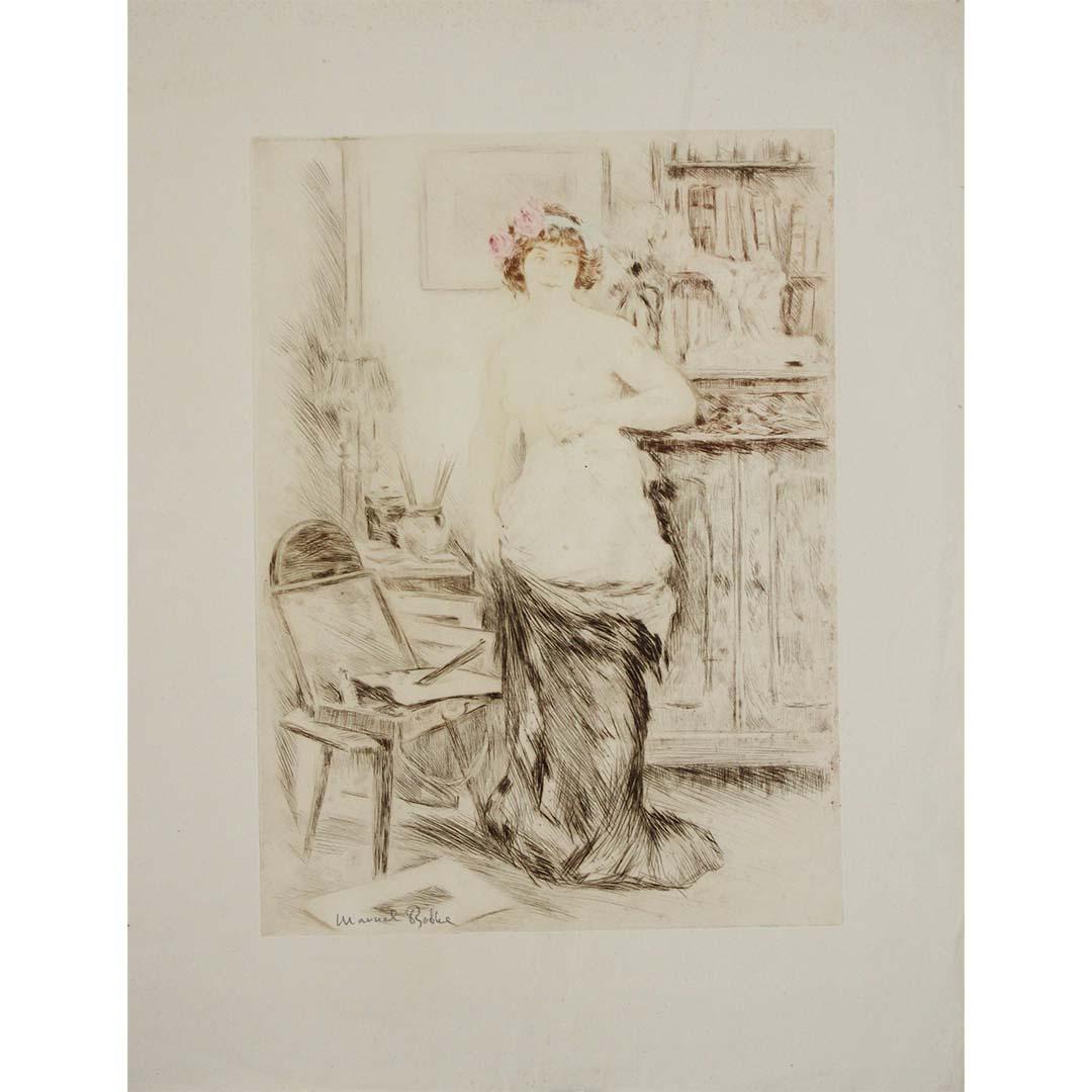 With La Jupe Ôtée (1906), Manuel Robbe once again captures the delicate boundary between modesty and sensuality—a recurring theme in his celebrated Belle Époque prints. The title, which translates to “The Skirt Removed”, reveals a moment suspended
