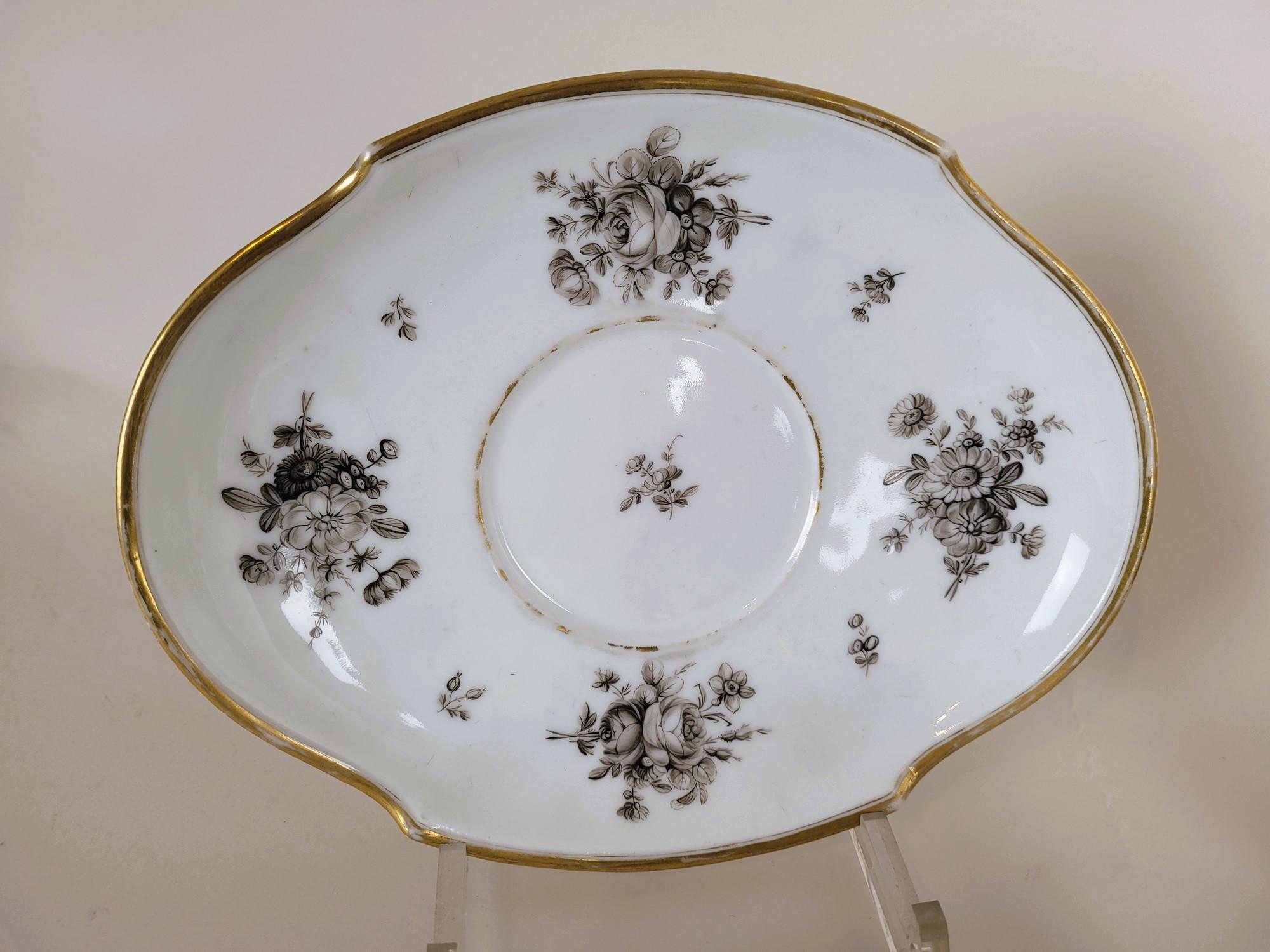 Part of a porcelain coffee service, decorated with black flowers on a white background, with gilding highlights on the edges.

It consists of 4 cups (good condition), 2 bowls (good condition), 1 milk jug (a chip under the spout and a small cooking
