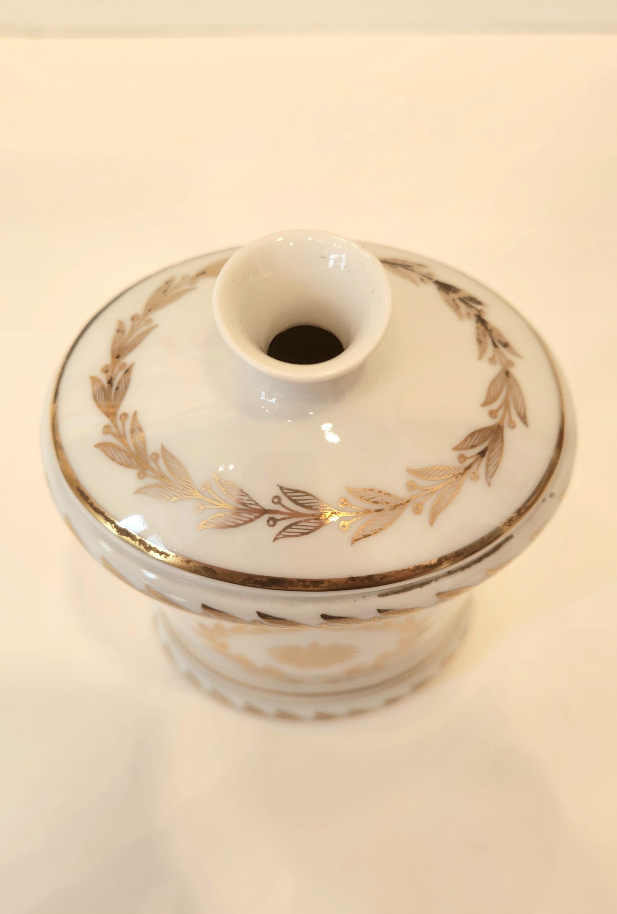 This beautiful Sevres vase is made of porcelain with a gold design and meant to hold a single flower. This hand painted porcelain vase is wonderful as decoration on its own, as well as holding flowers or greenery. The style of the design is very