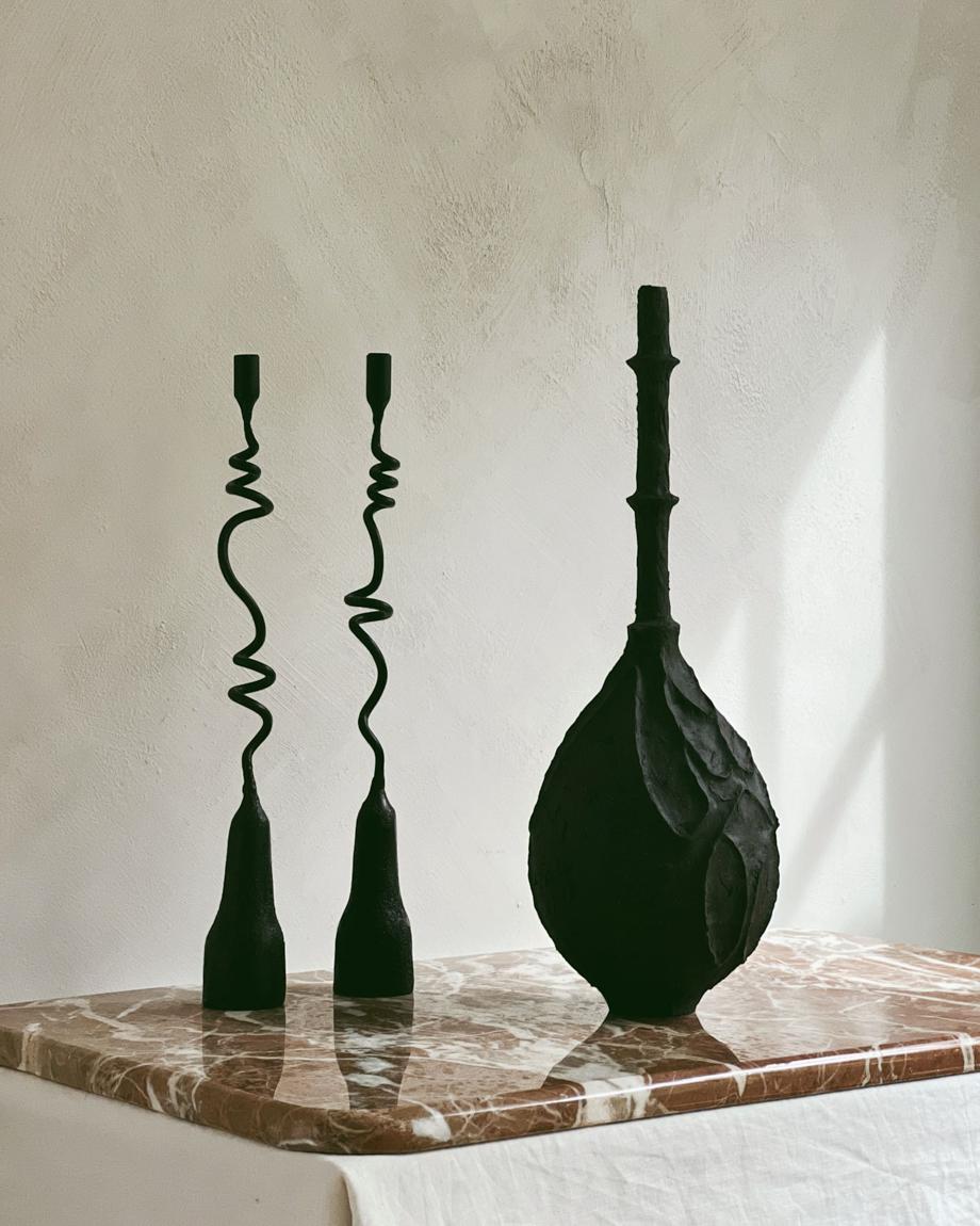 Manzanita is a mismatched set of handmade iron candlesticks from The Iron Series. With twisted stems and a solid base, the pair take on a life on their own. Built to house two taper candlesticks, the sculptural set may also be styled as objet d'art