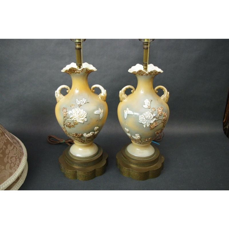 Offering a Pair of midcentury Mao Period Porcelain Amphora Chinese Table Lamps with Shades
Featuring Elephant Head Handles, Hand Painted Moriage Butterflies, and an Embossed Floral (Peonies) Design with Reticulated 2 Tier Open-Work Brass