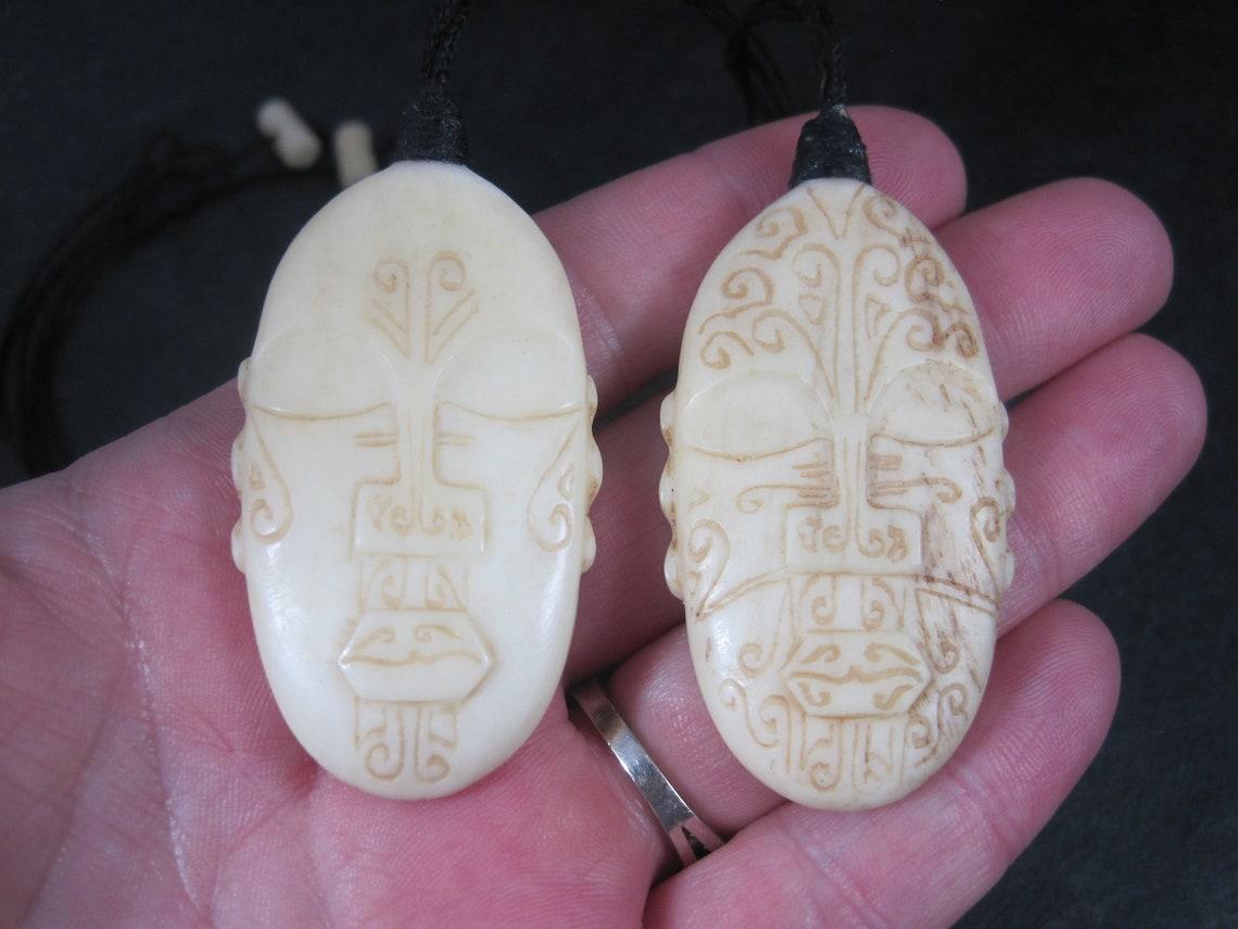These beautiful, one-of-a-kind Maori Necklaces are the creation of the famed Paul Gyde; aka PaulZ, aka Kiwi Keeps.

They feature Ranginui, the father of creation and Papatūānuku, the mother of creation.

They are carved from sun-dried cattle/beef