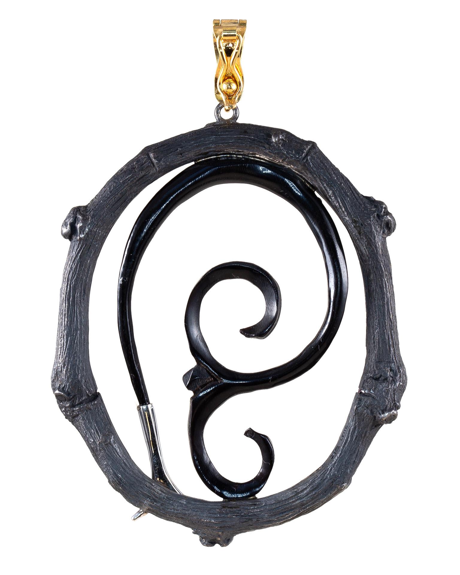 This Time Traveler pendant is composed of carved buffalo horn with 18k white and .07 carat total weight diamonds and black oxidized sterling silver frame. 

The Body Armor Collection embodies eternal symbols of protection that are both tribal and