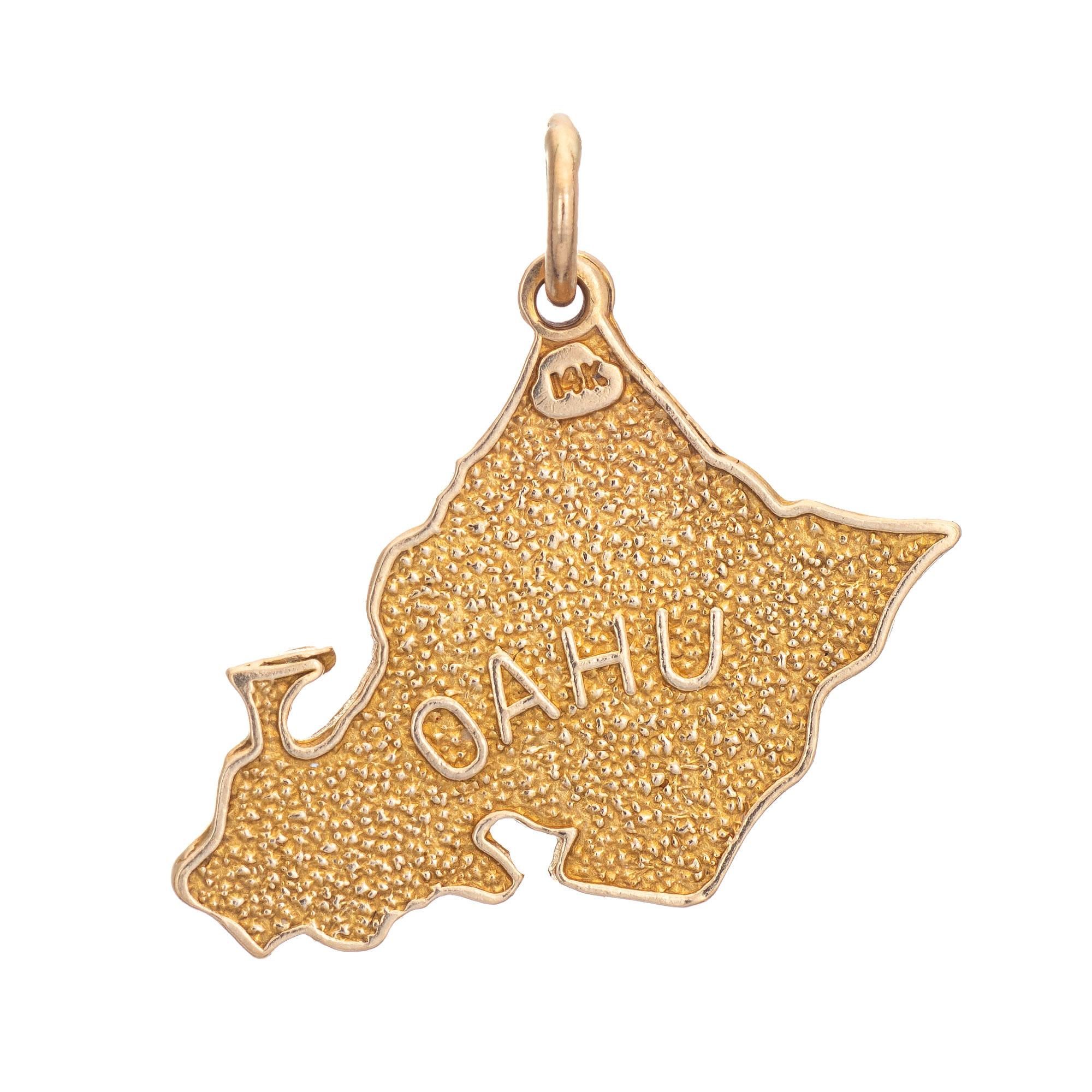 Finely detailed vintage Oahu charm crafted in 14k yellow gold.  

The unique charm highlights a Map of Oahu. One side highlights 'Oahu' with the reverse side highlighting 'Honolulu' along with a pineapple and a wave like design. The bale measures