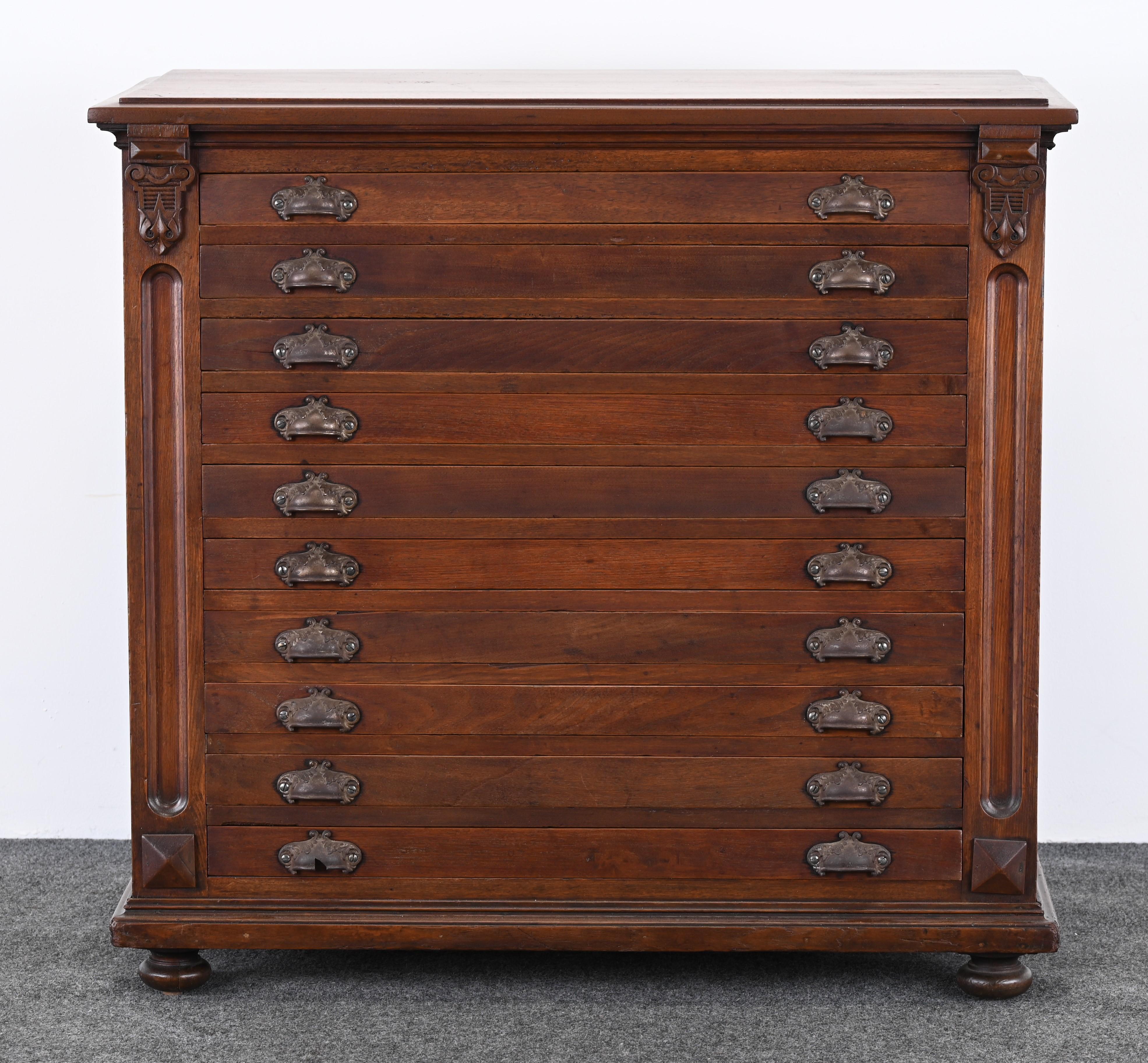 A handsome solid walnut map or print cabinet with ball feet and stylish drawer pulls. This cabinet dates from the 19th Century and has fine American craftsmanship. Restored mellow fine finish, some wear to surface as shown in images. Structurally