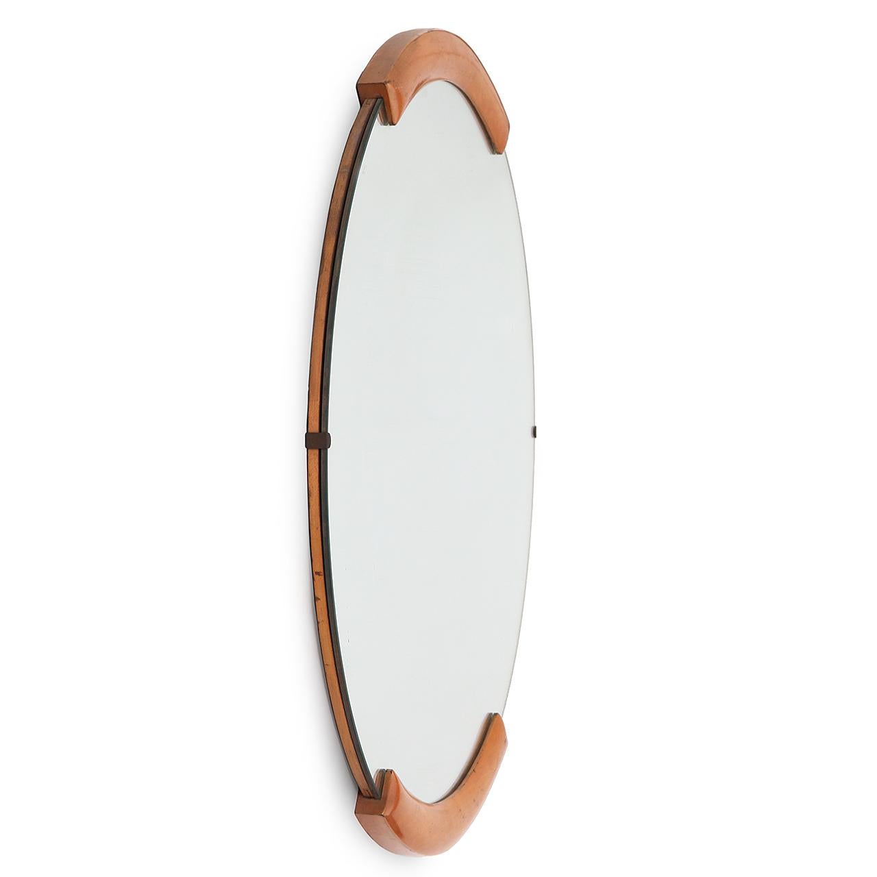 A masterfully simple Art Deco maple-accented wall mirror from Russel Wright's seminal American modern furniture line.