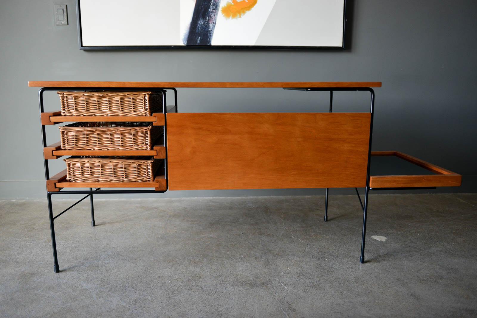 Maple and iron desk by Dorothy Schindele for Modern Color, circa 1950. From the Pacifica Line by Modern Color of California. Original willow side baskets on sliding drawers. Smoked glass shelf for books or additional storage. Extremely rare, hard to