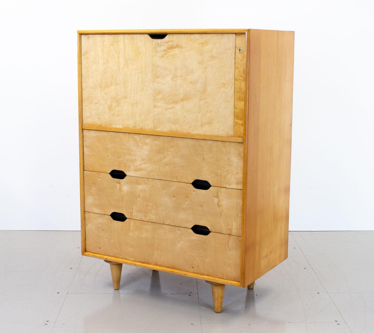 1950s bureau designed and made by Vesper for Heal’s of London. Pieces from this range are rare to see. It has a solid beech carcass and maple veneered drawer and door fronts with recessed handles and tapered legs. There are 3 good sized drawers made