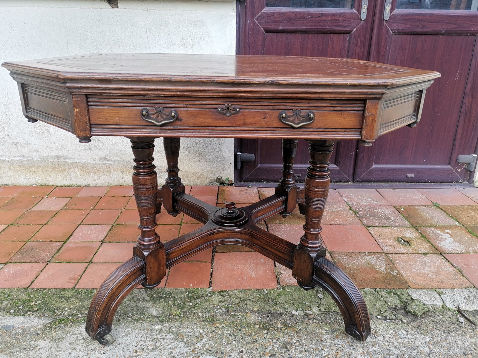 Maple & Co. a Gothic Revival Oak Leather Top Writing Table on Decorative Castors For Sale