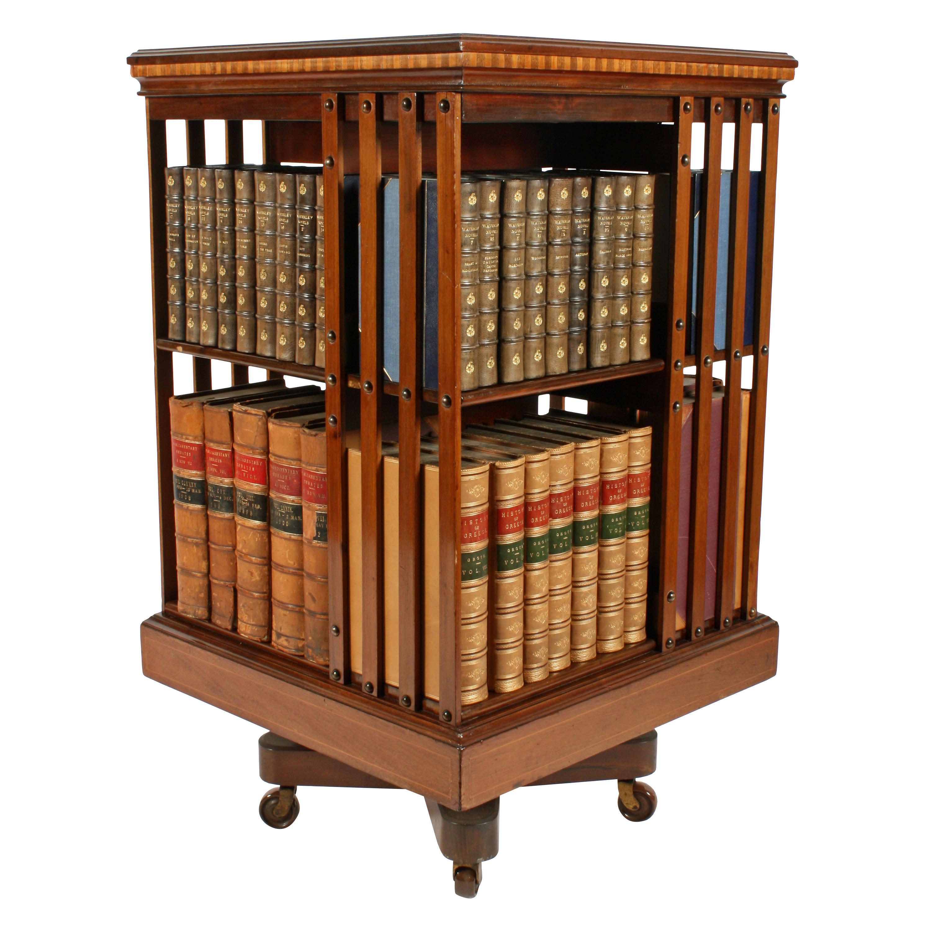 A late 19th century inlaid mahogany revolving bookcase by Maple & Co of London.

The top of the bookcase has a panel of marquetry inlay and has box wood line inlay.

The molded edge has a dental inlay of mahogany and box wood.

The mechanism