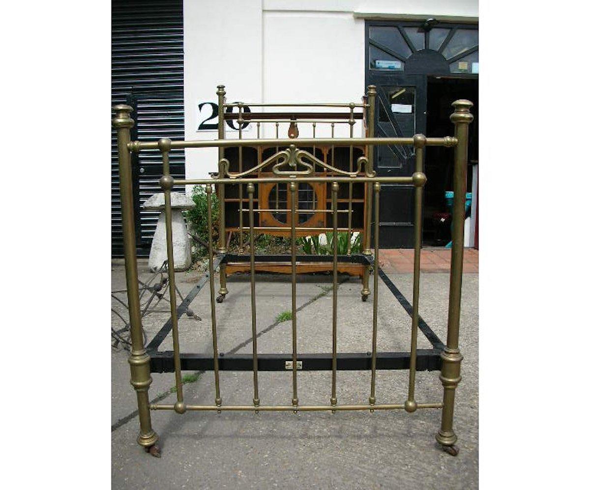 Maple & Co. A good quality Arts & Crafts brass 3 foot wide single bed with stylized floral details to the head and the foot boards.