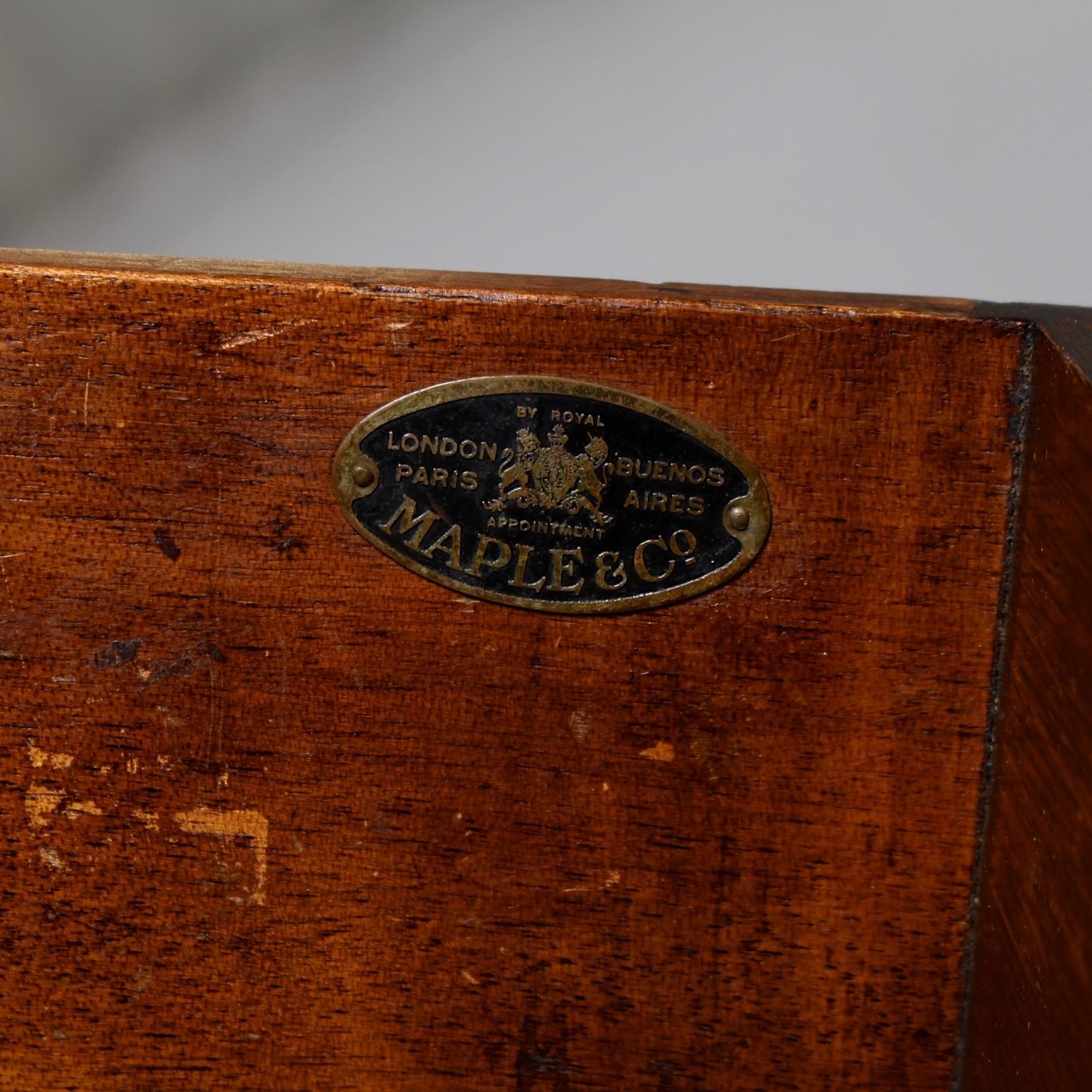 Maple & Co oak sideboard.

Arched upstand on rectangular moulded top above two drawers to frieze with fitted interiors above paneled bead mounted cupboards above a carved apron supported on bulbous turned legs joined by an H-shaped