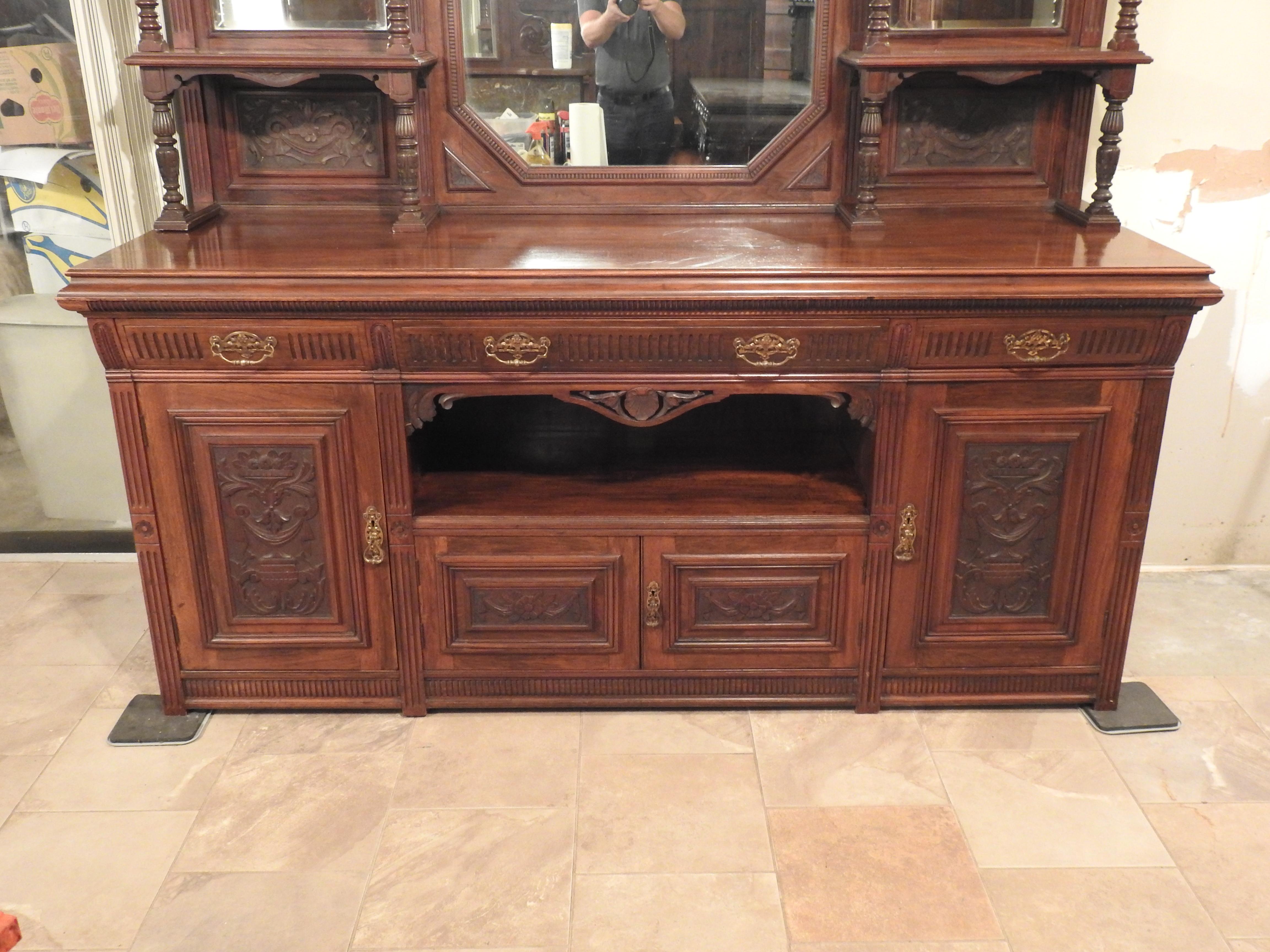 Offering this stunning piece by Maple & Co. out of Paris, France. Having two larger doors and two smaller doors with a cubby space above that, and 4 drawers across the top of doors on the base. The top is stepback having a large mirror in center.