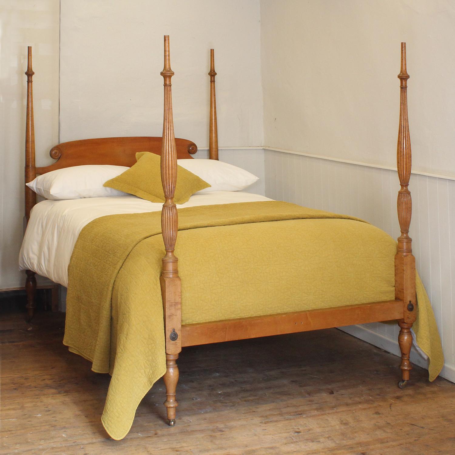 A fine example of an American Federal Four Poster Bed fashioned from maple and originating from the USA in the early Nineteenth century. The back has an subtle curve backboard with scroll ends and simple turned posts. The foot posts are reeded with