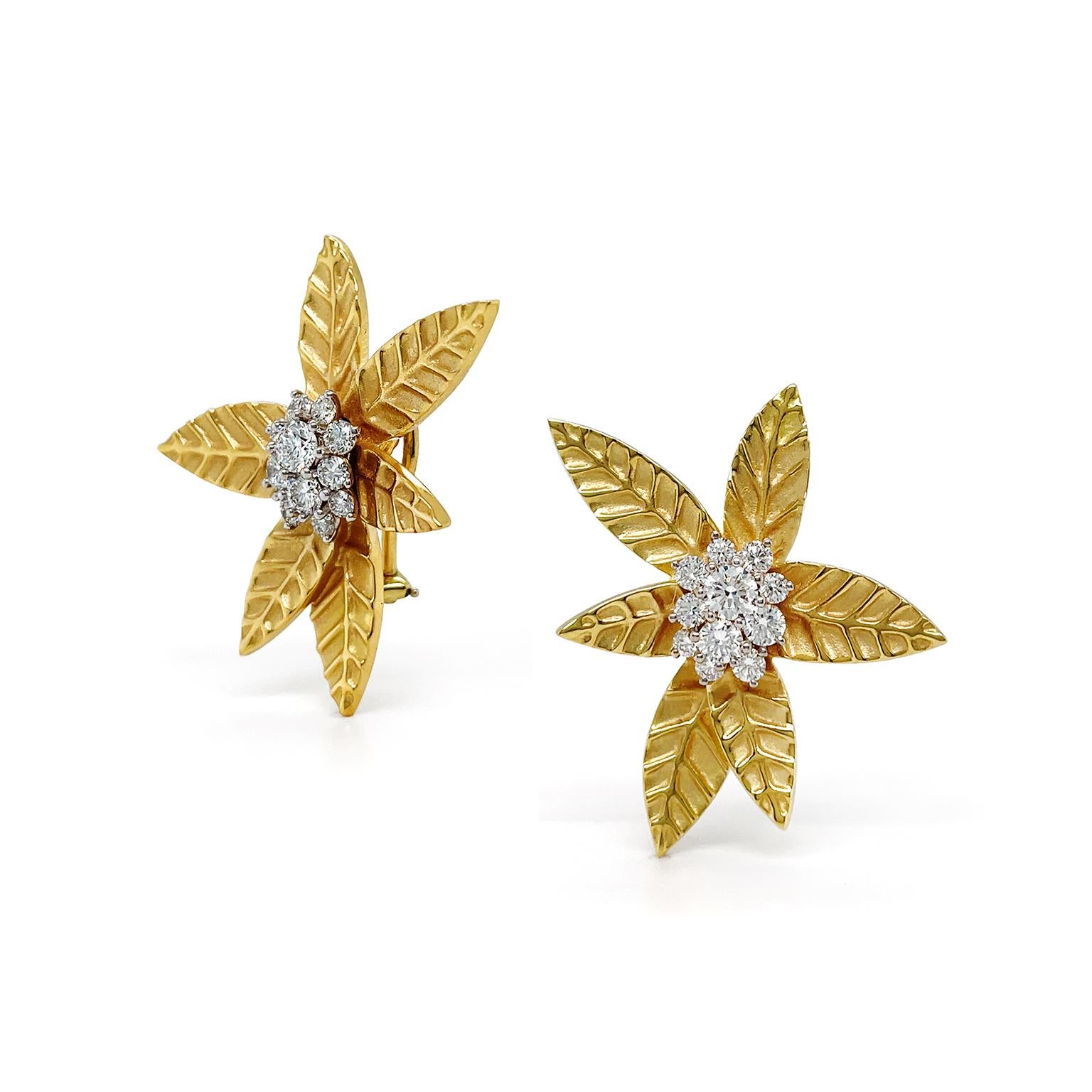 A gilded maple leaf is depicted in 18k yellow gold and shimmers with an array of brilliant cut diamonds for these earrings. Crafted with attention to detail, a cluster of six golden leaves of varying sizes shines brightly. Intricate vein patterns