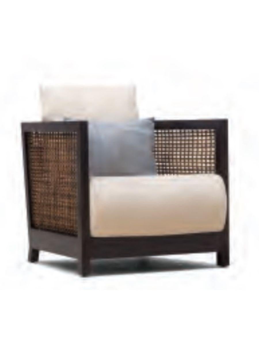 Maple lowback suzy wong easy armchair by Kenneth Cobonpue.
Materials: abaca, rattan, maple. 
Also available in walnut.
Dimensions: 76 cm x 71 cm x H 64 cm.

Woven panels create a feeling of intimacy as you and your guests indulge in