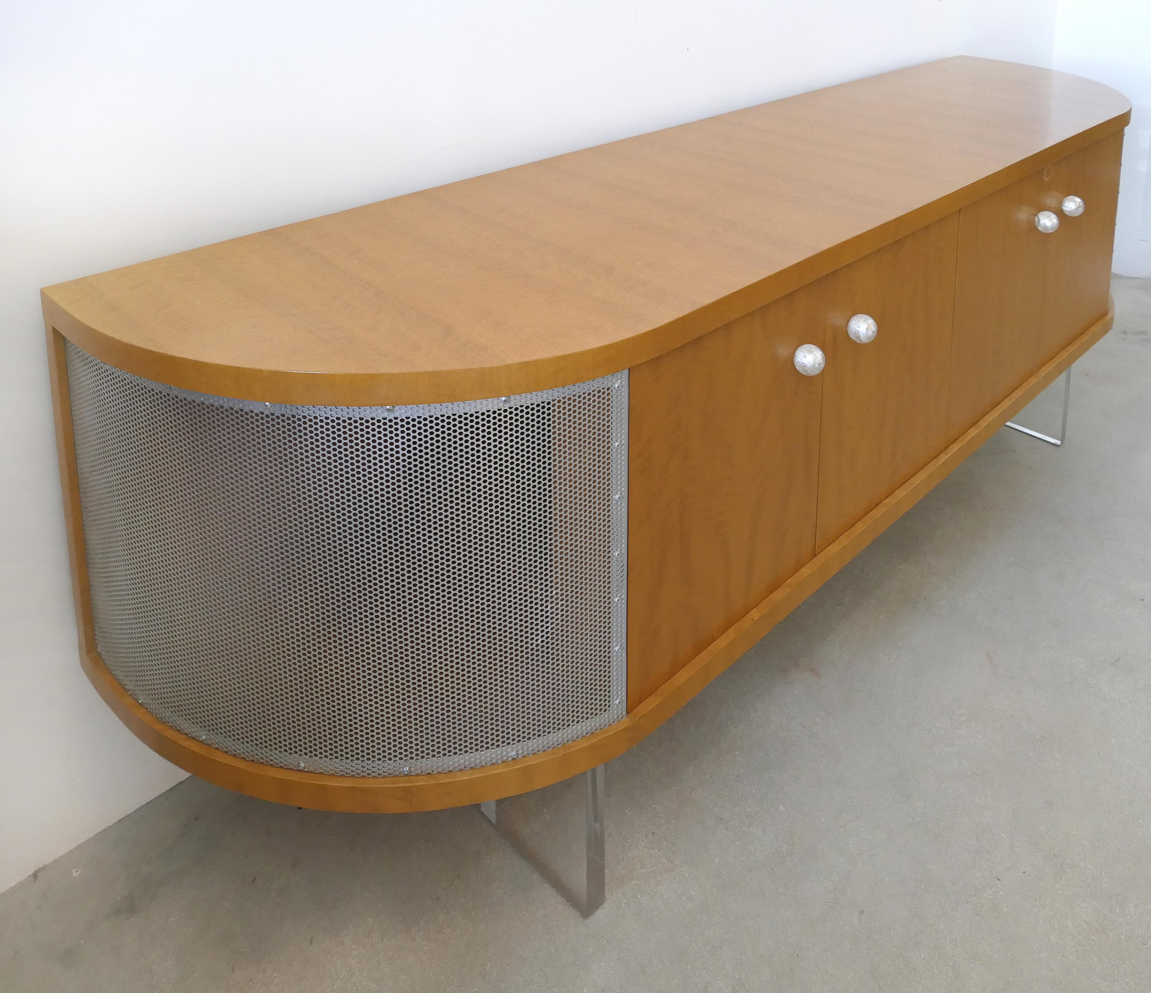 Maple media cabinet/credenza with Lucite base and glass handles, custom made

Offered for sale is a custom made maple wood media cabinet with beautifully matched grain maple veneers, blown glass handles, a thick Lucite base and pierced metal