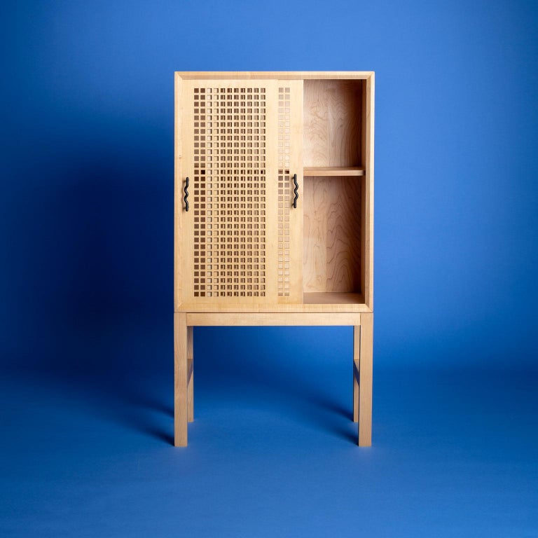 Prototyped in the weeks leading up to a solar eclipse, this bar cabinet is an exploration of partially obscured light. The laser cut lattice work on the bypass doors is an interpretation of the Mosharabi screens found in Moorish architecture.