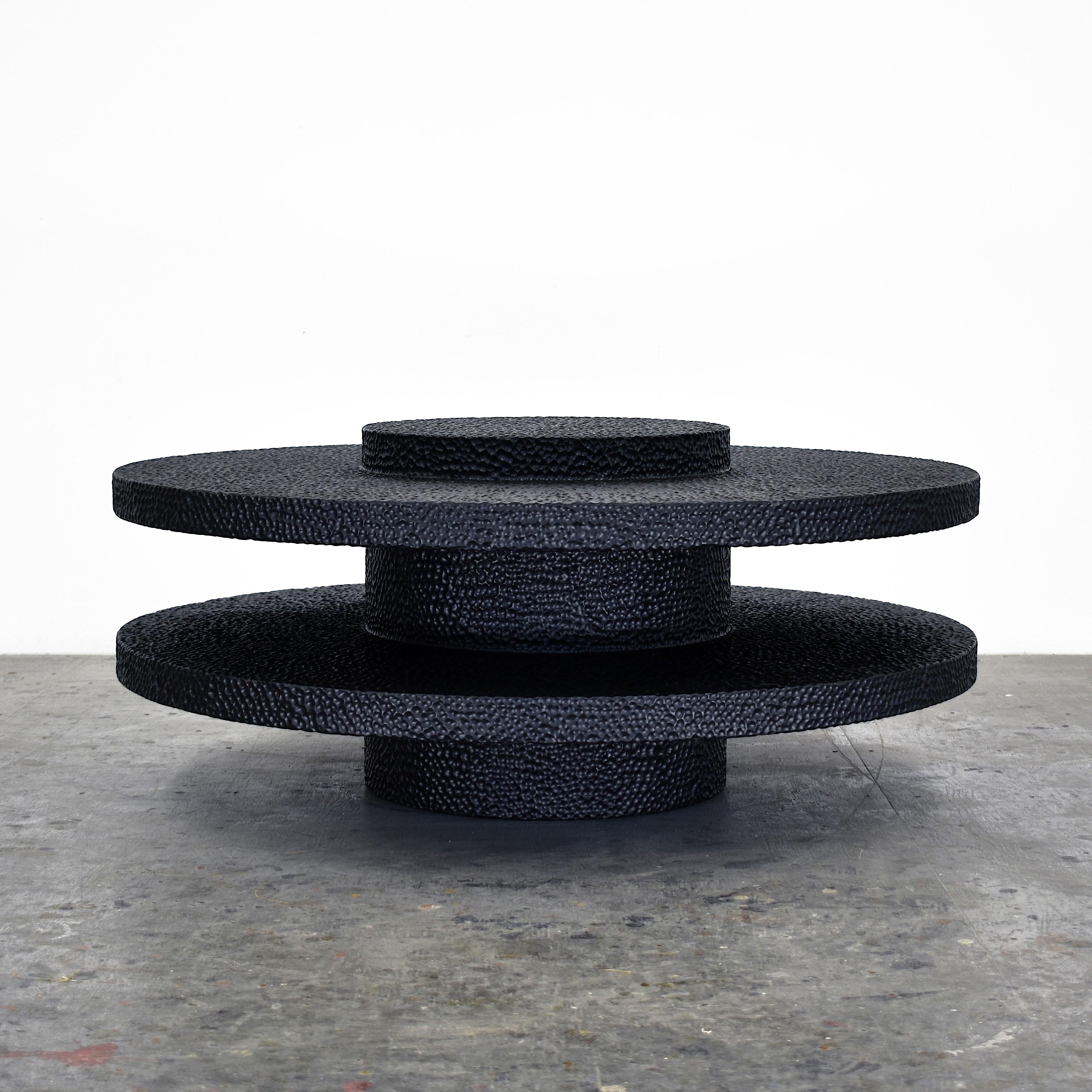 Maple round table sculpted by John Eric Byers
Dimensions: 45.7 x diameter 107 cm
Materials: Carved blackened maple

All works are individually handmade to order.

John Eric Byers creates geometrically inspired pieces that are minimal,