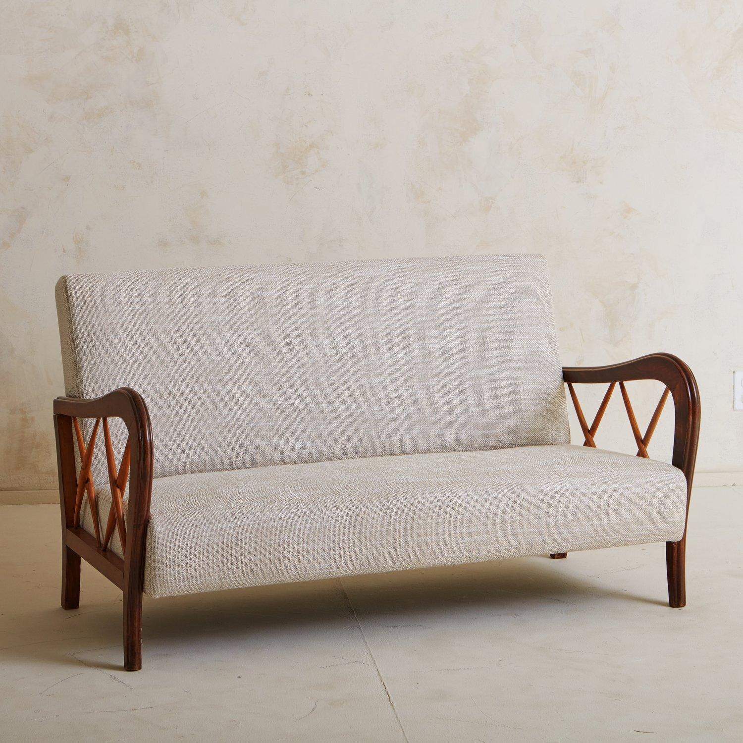 A vintage Italian wood frame settee in the style of Paolo Buffa. This piece has beautiful curved maple wood arms with x-detailing and slightly angled legs. It was newly reupholstered in a textured, woven taupe fabric. Sourced in Italy, 20th