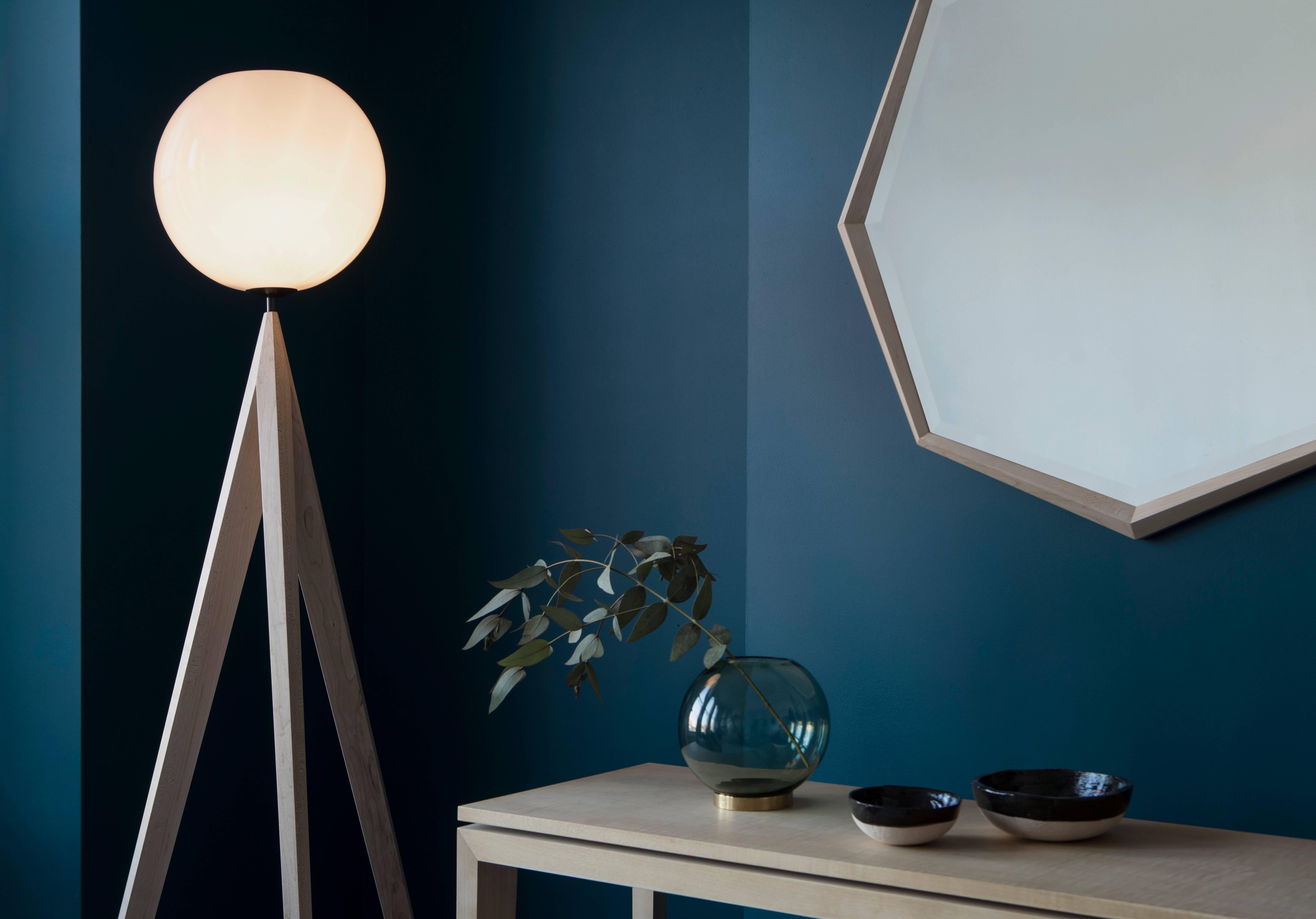 The Lunar floor lamp plays on the idea of perspective. Its legs are designed to look as if they defy gravity. They lift the eye and seem to float off the ground. The shade gives off a cool, calm light, reminiscent of a full moon. The piece makes