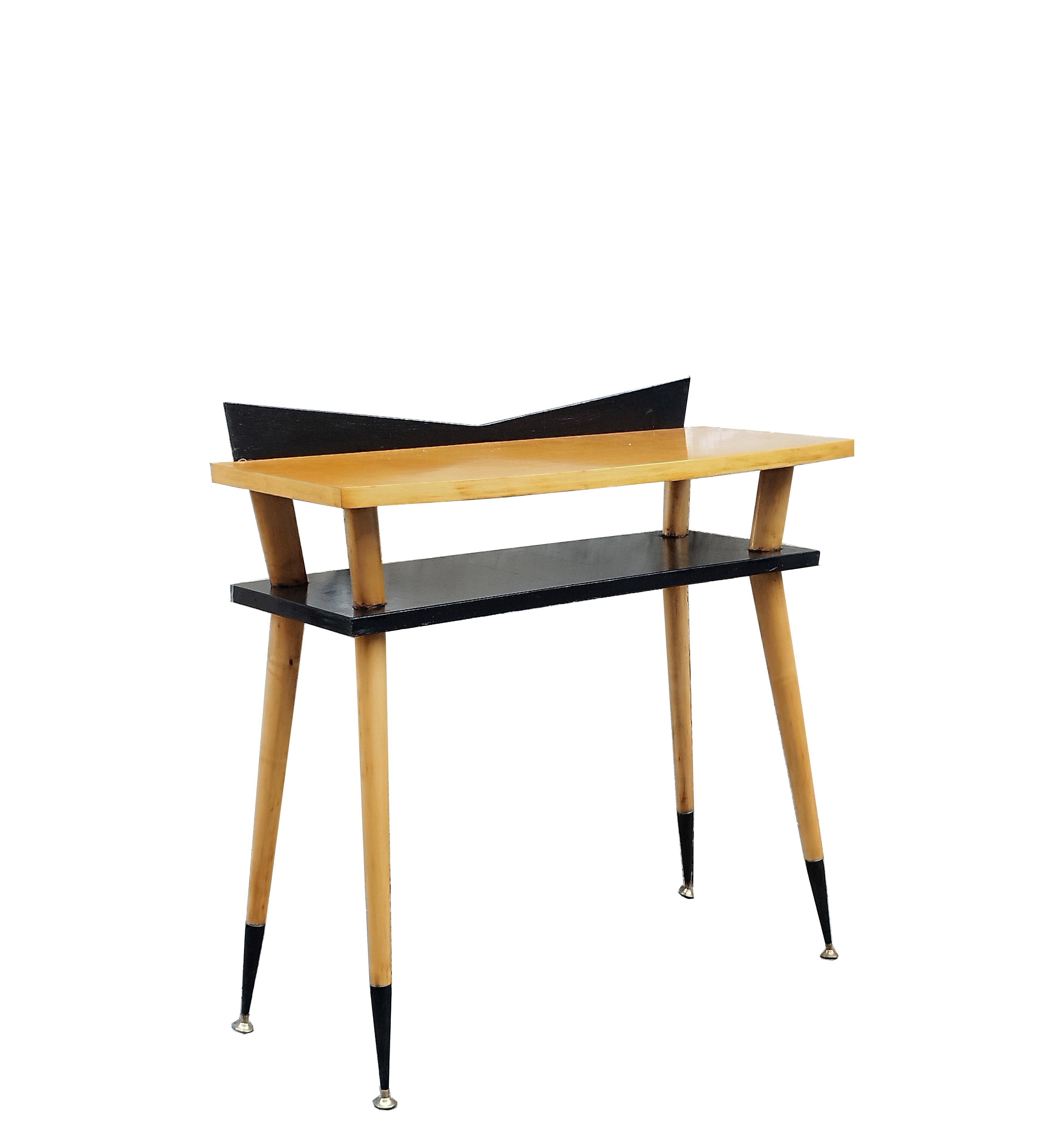 Rare Mid Century Modern period console table in maple, ebonized wood and brass finials.