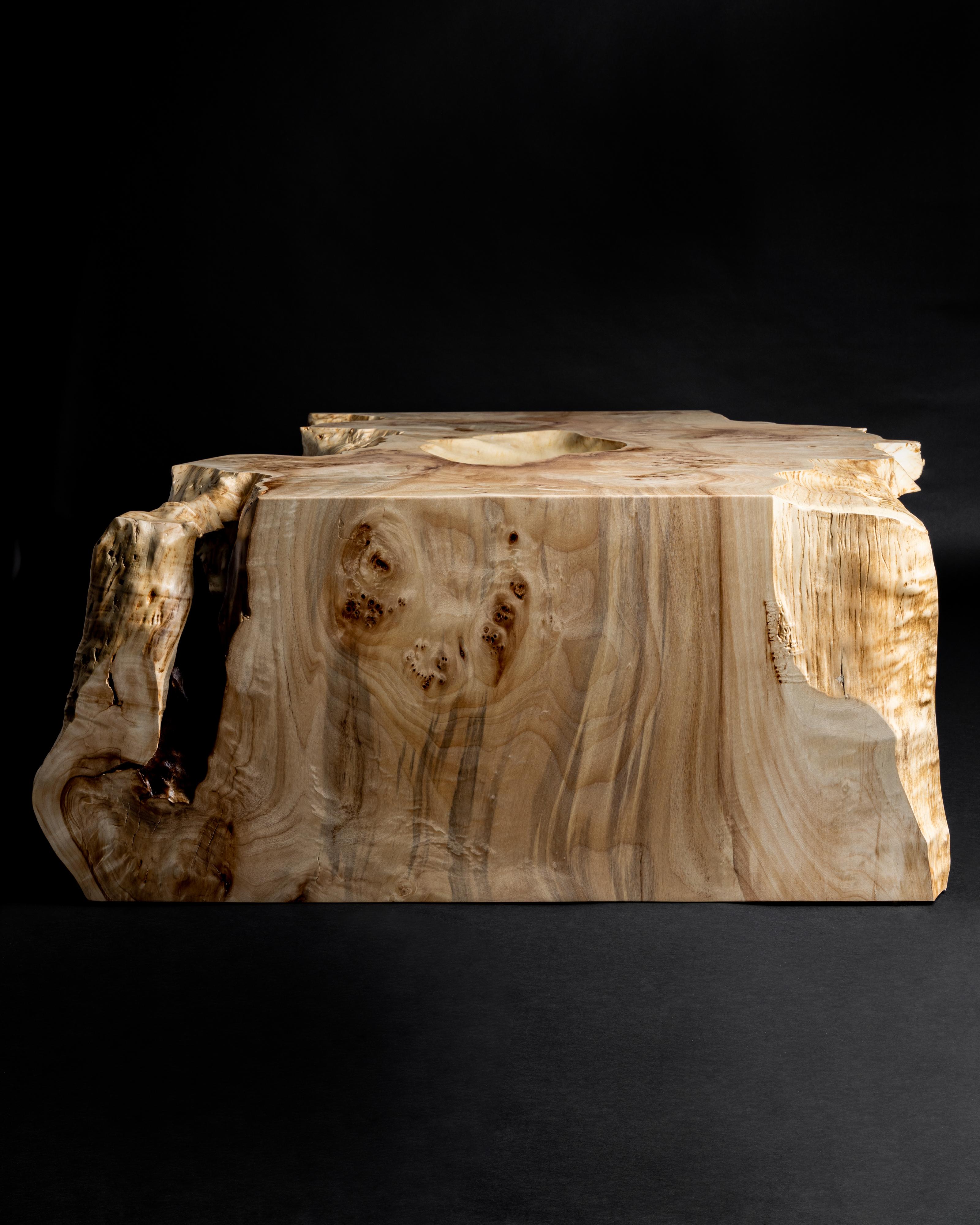 A huge single slab of French Mappa Burl folded to create a waterfall effect over the ends of the table. The live edge is wildly organic and a naturally occurring hollow adds dimension to the table top while remaining functional. 

The table as