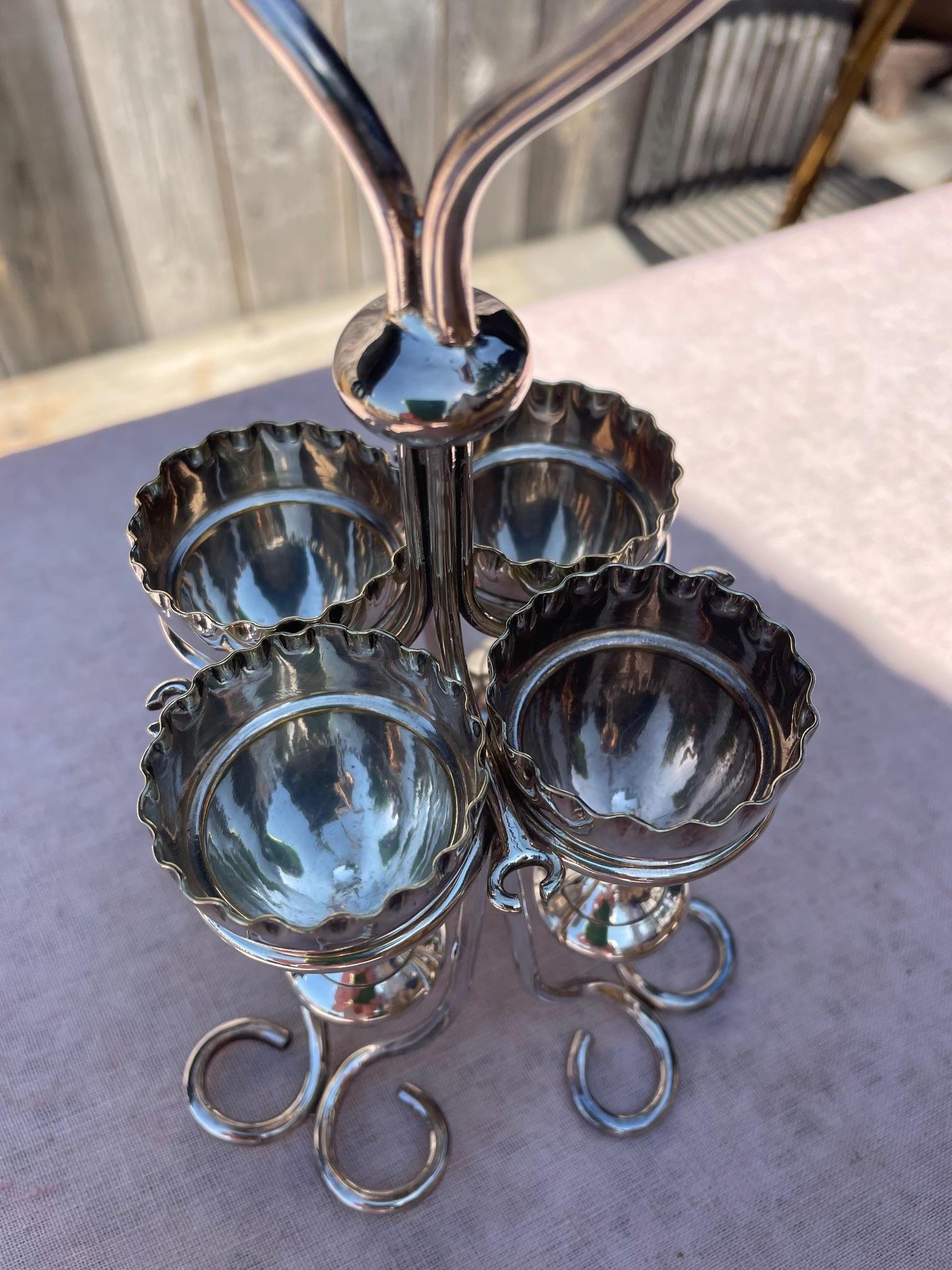 Support for 4 egg cups in silver metal from Wappin and Webb, hallmark on the bottom of the support.
Support with a heart on top.