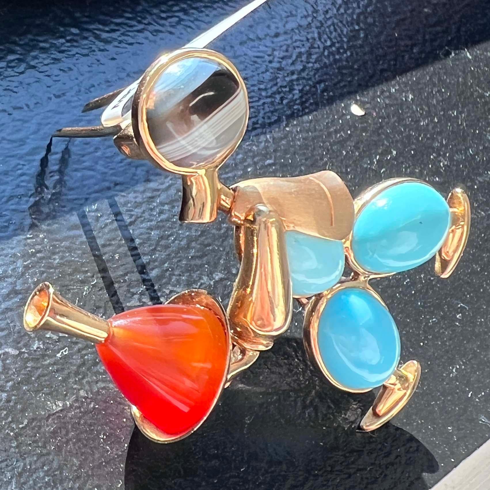 Mappin & Webb 18k yellow gold waiter brooch by the famous British jewelry designer house Mappin and Webb. This brooch features a playful waiter character crafted from vibrant gemstones, including bright blue turquoise. Its unique design adds a touch